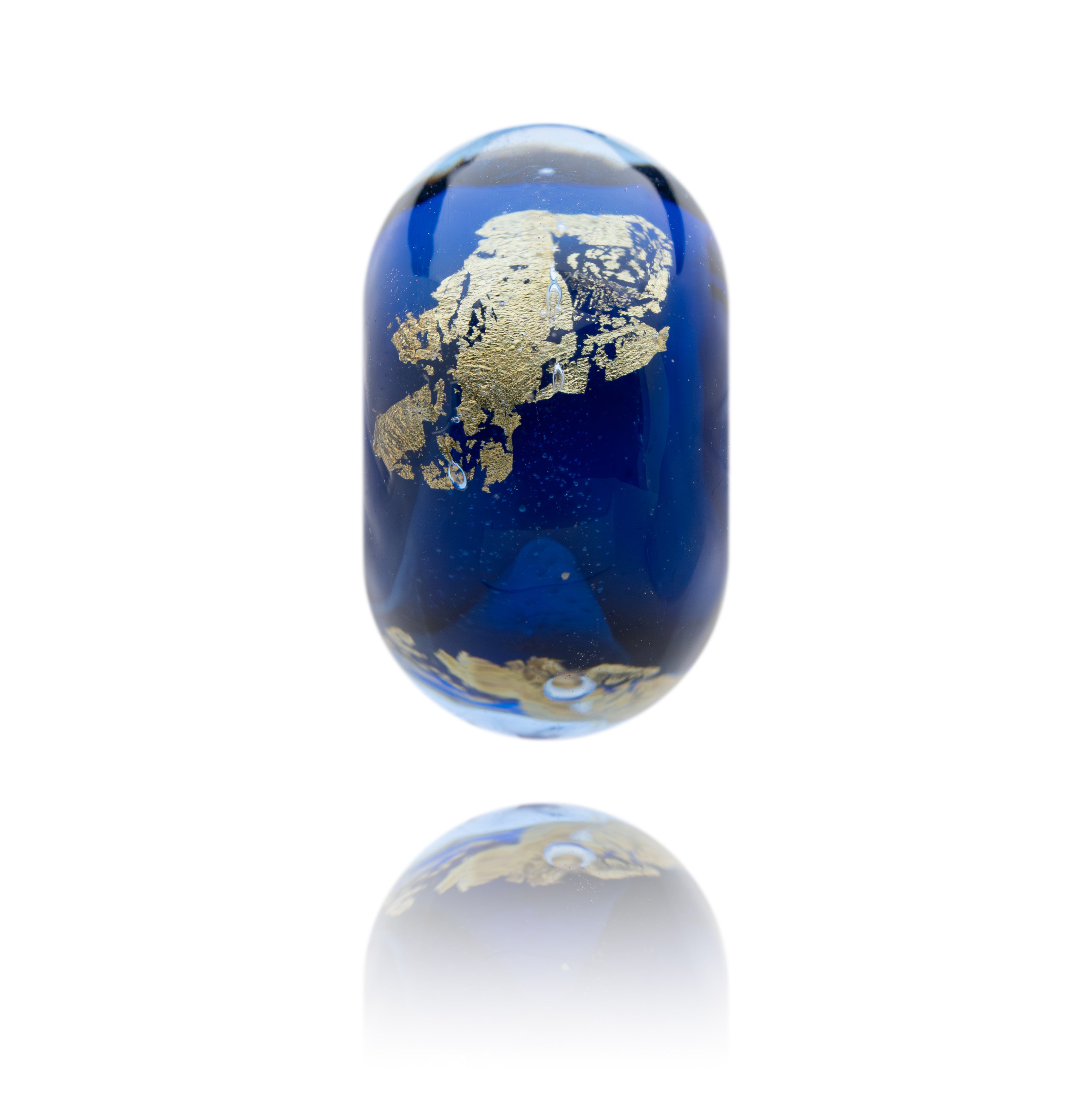 Blue glass object with gold map design on a white background