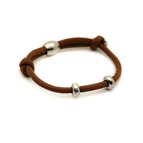 Brown braided bracelet with silver beads on a white background