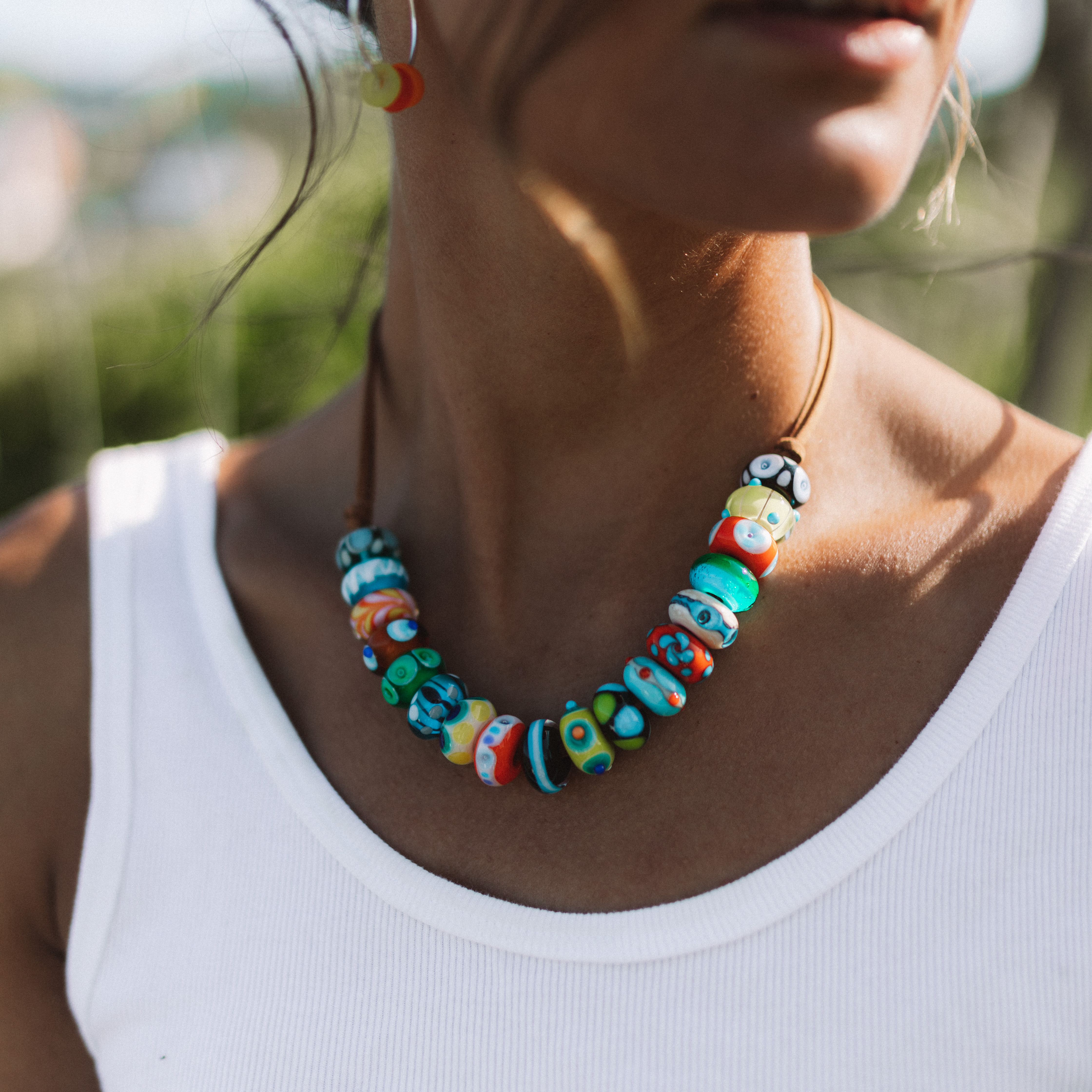 Brown cord necklace with colourful glass beads.