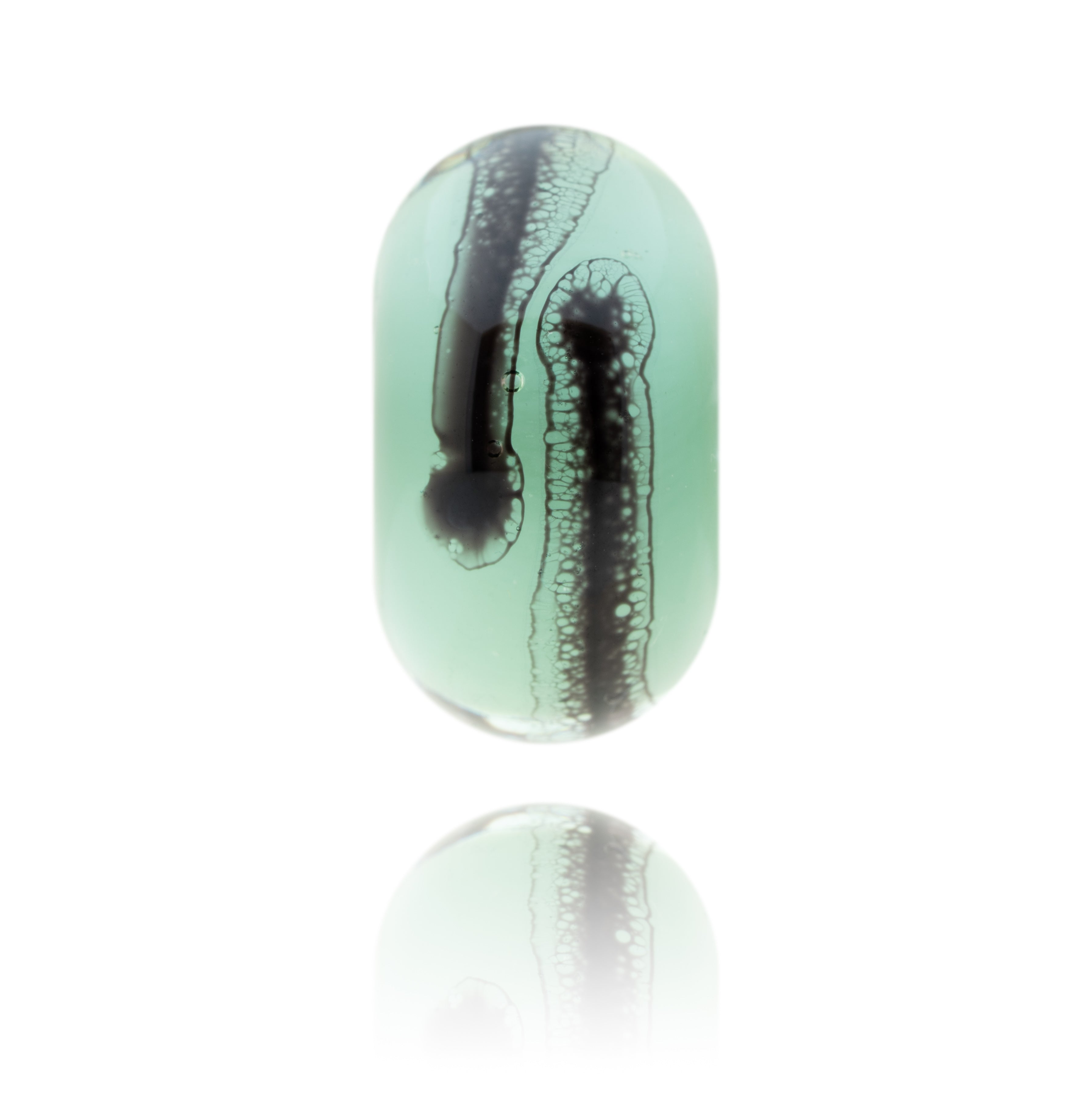 Green and clear glass bead with black webbed patterns on the surface representing Clevedon Pier in Somerset.