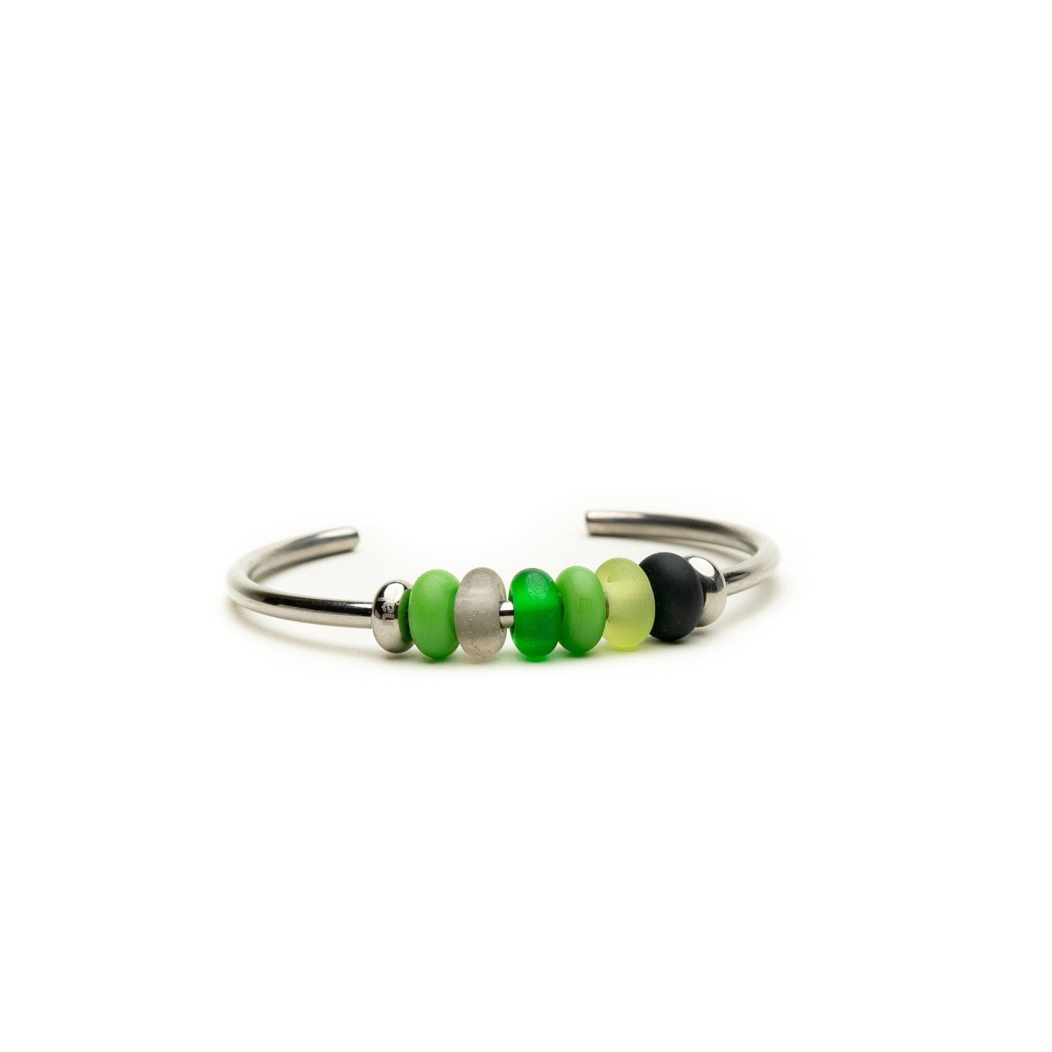 Silver bangle with small glass beads in shades of green.