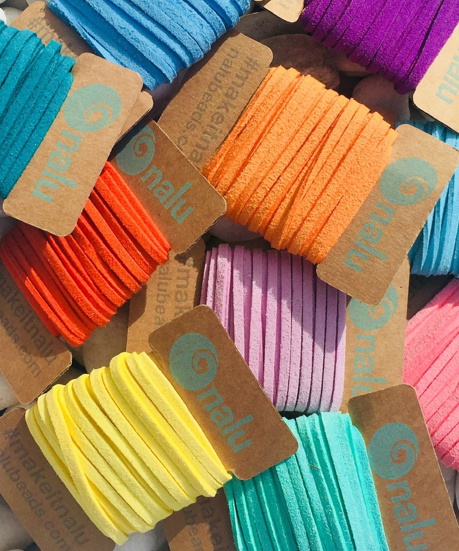 Colorful cords in various shades with 'nalu' brand tags.