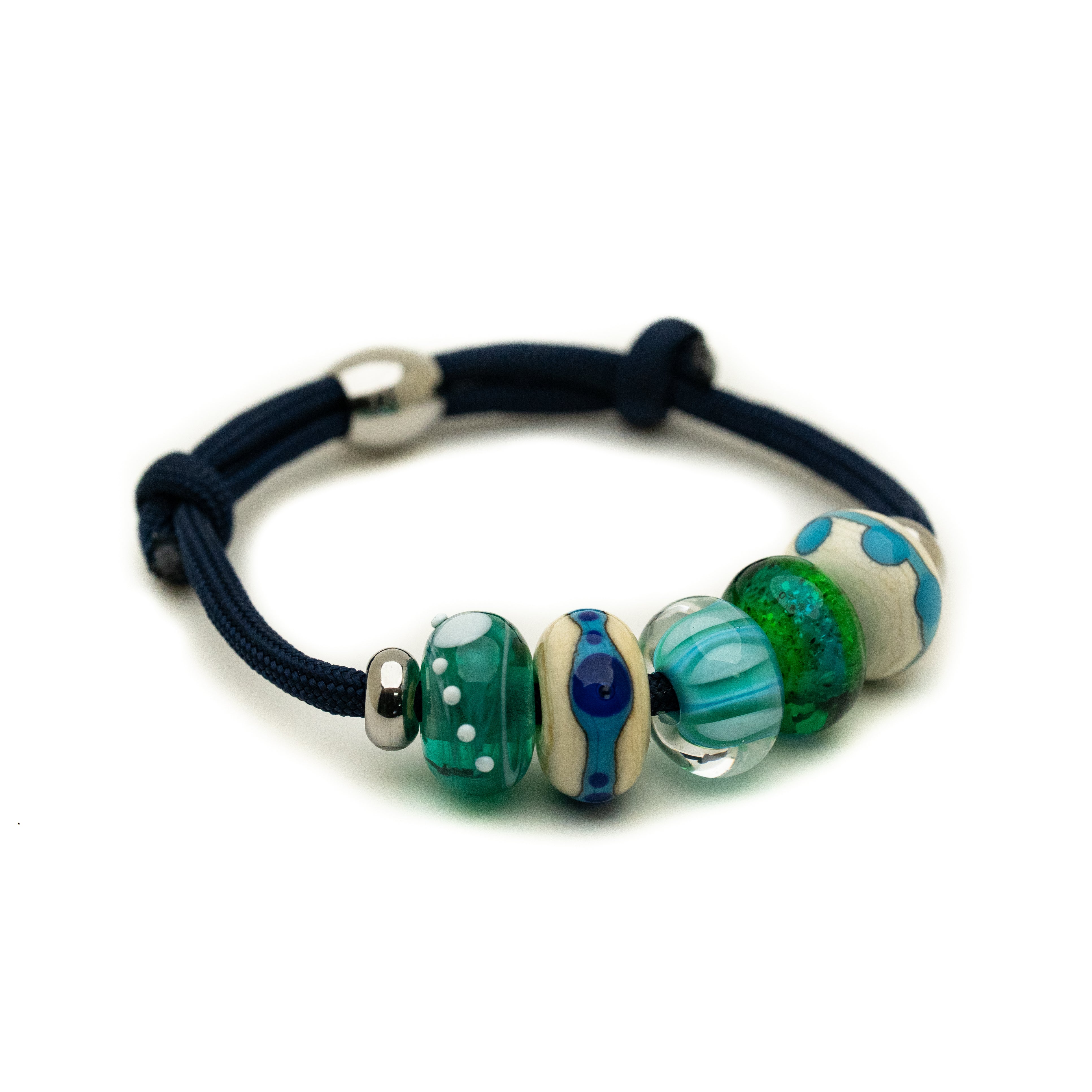 Blue, green and sand coloured glass beads on navy bracelet.