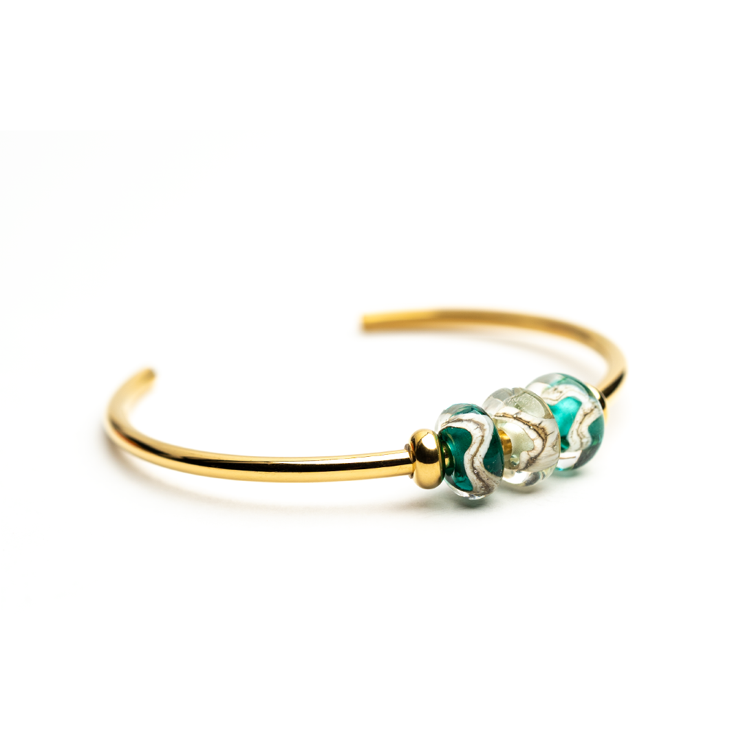 Cornish coastline beads on gold bangle.