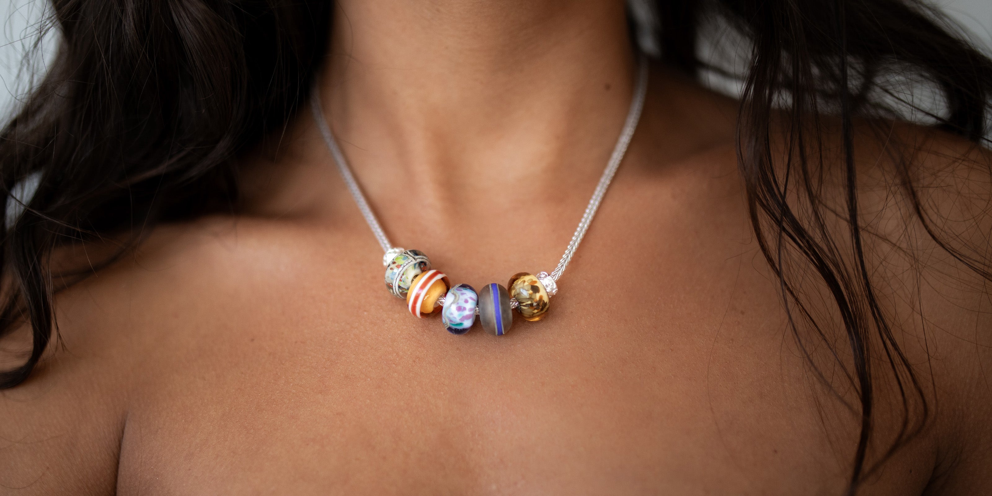 Northern beach glass beads on a silver necklace.