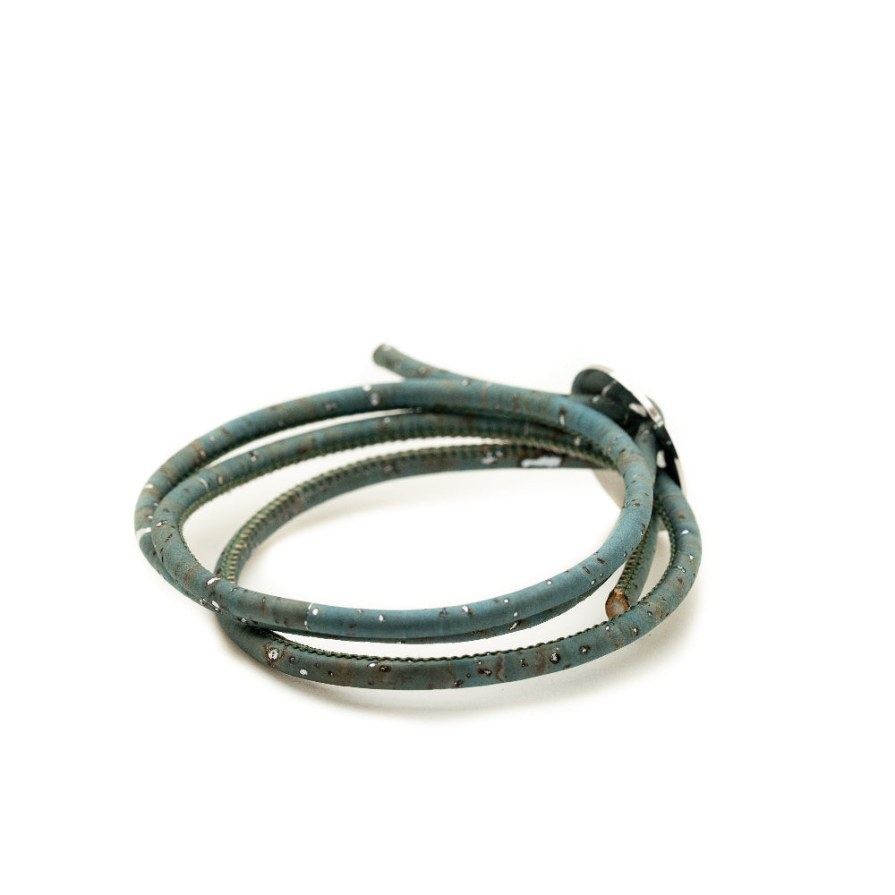 Coiled blue leather cord on a white background
