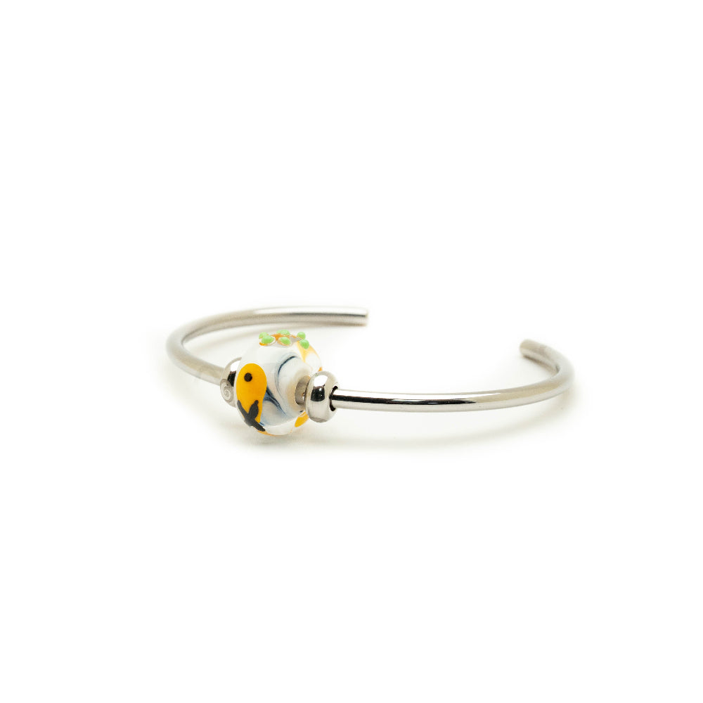 Stainless steel bangle with patterned fish and chips glass bead attached.