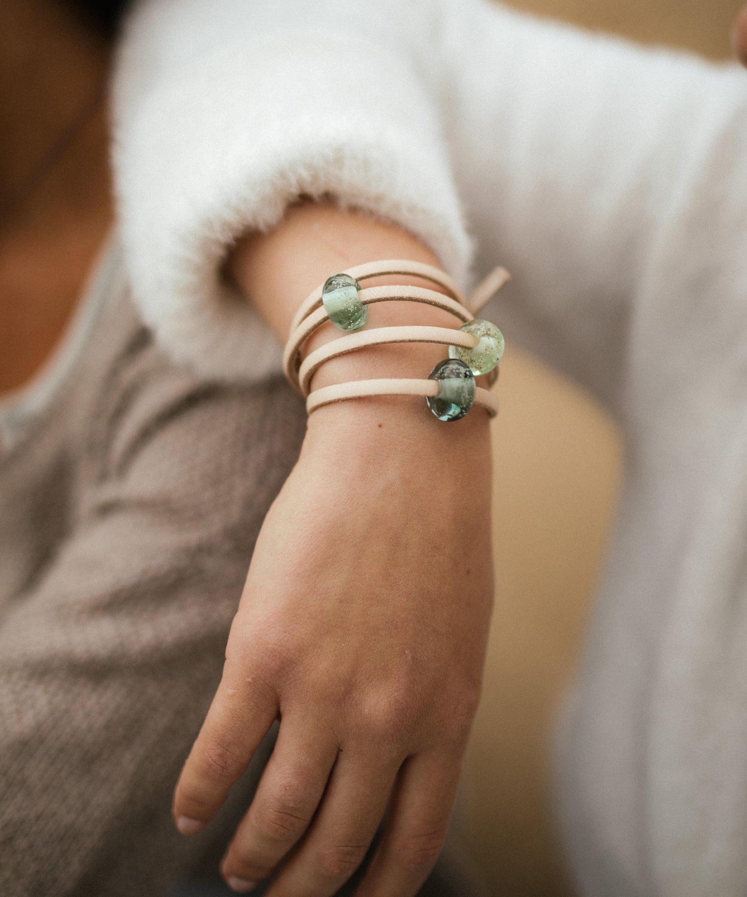 Green, grey and clear sand beads on sand leather wrap style bracelet.