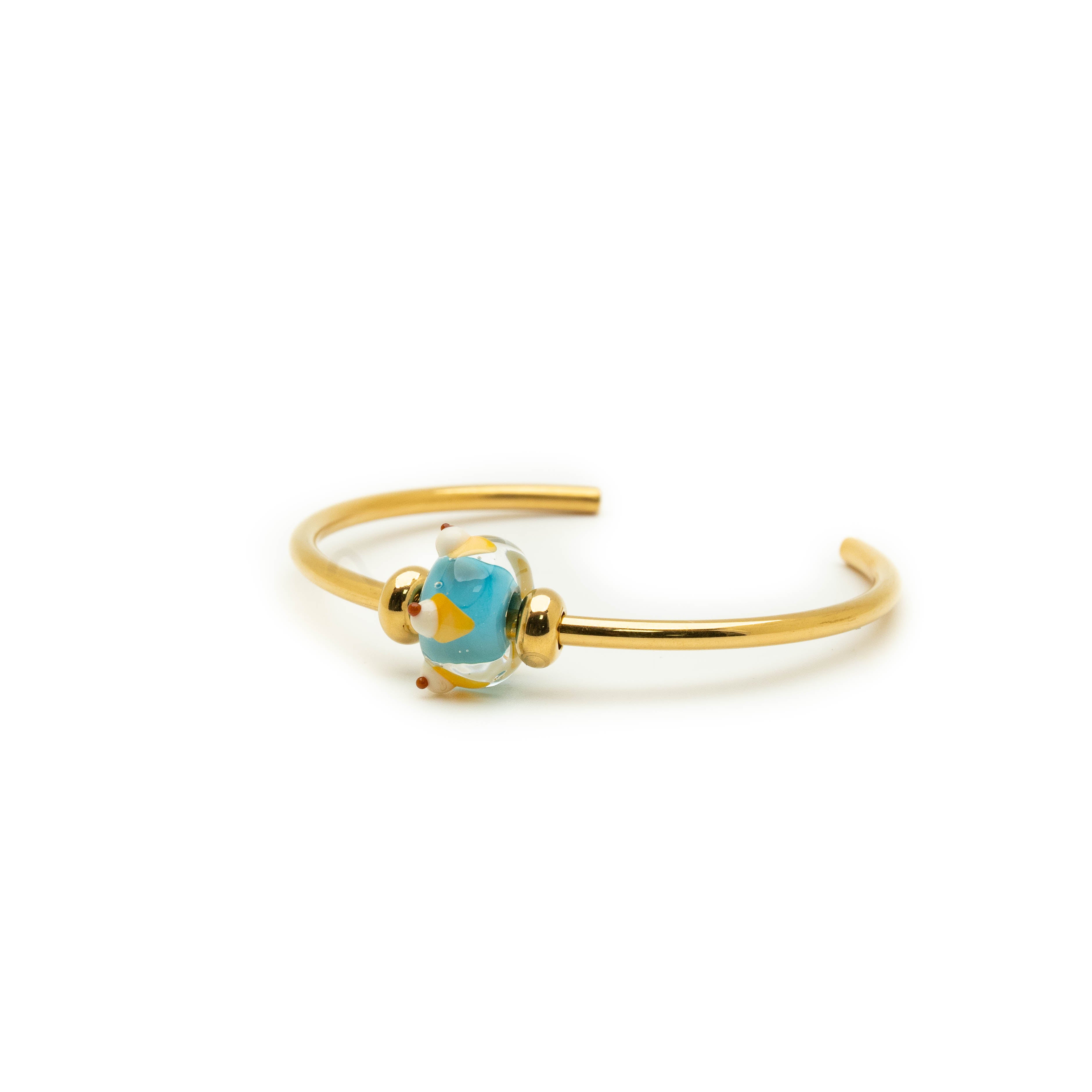 Gold bangle with glass ice cream bead.
