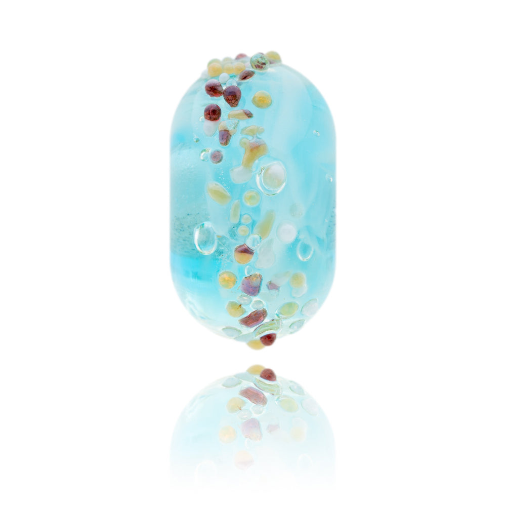 Turquoise glass bead with colourful dots on surface, representing the Isle of Harris in Scotland.