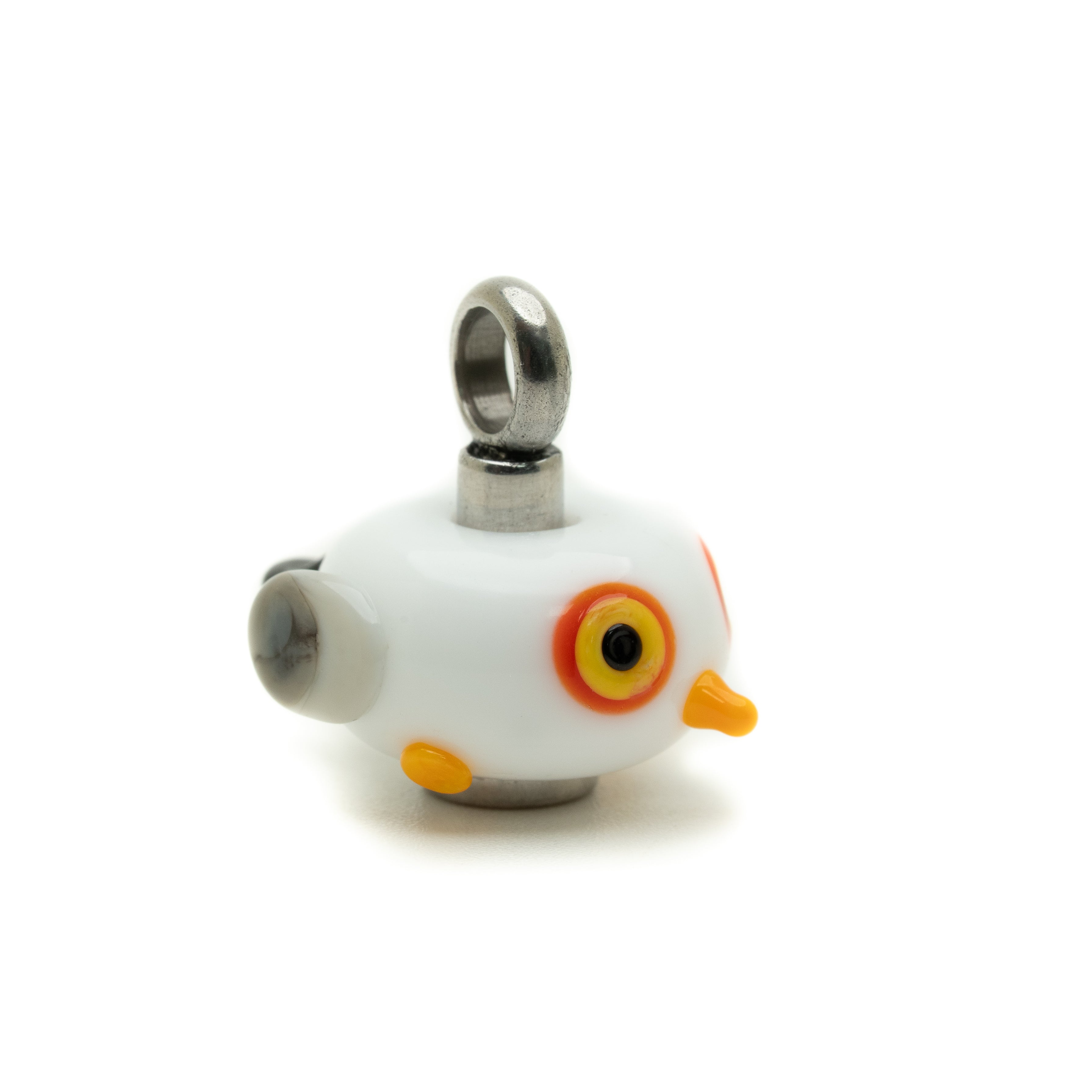 A small white bird-shaped charm with orange and yellow details, featuring a silver metal loop at the top and a silver side detail, shown on a plain white background.