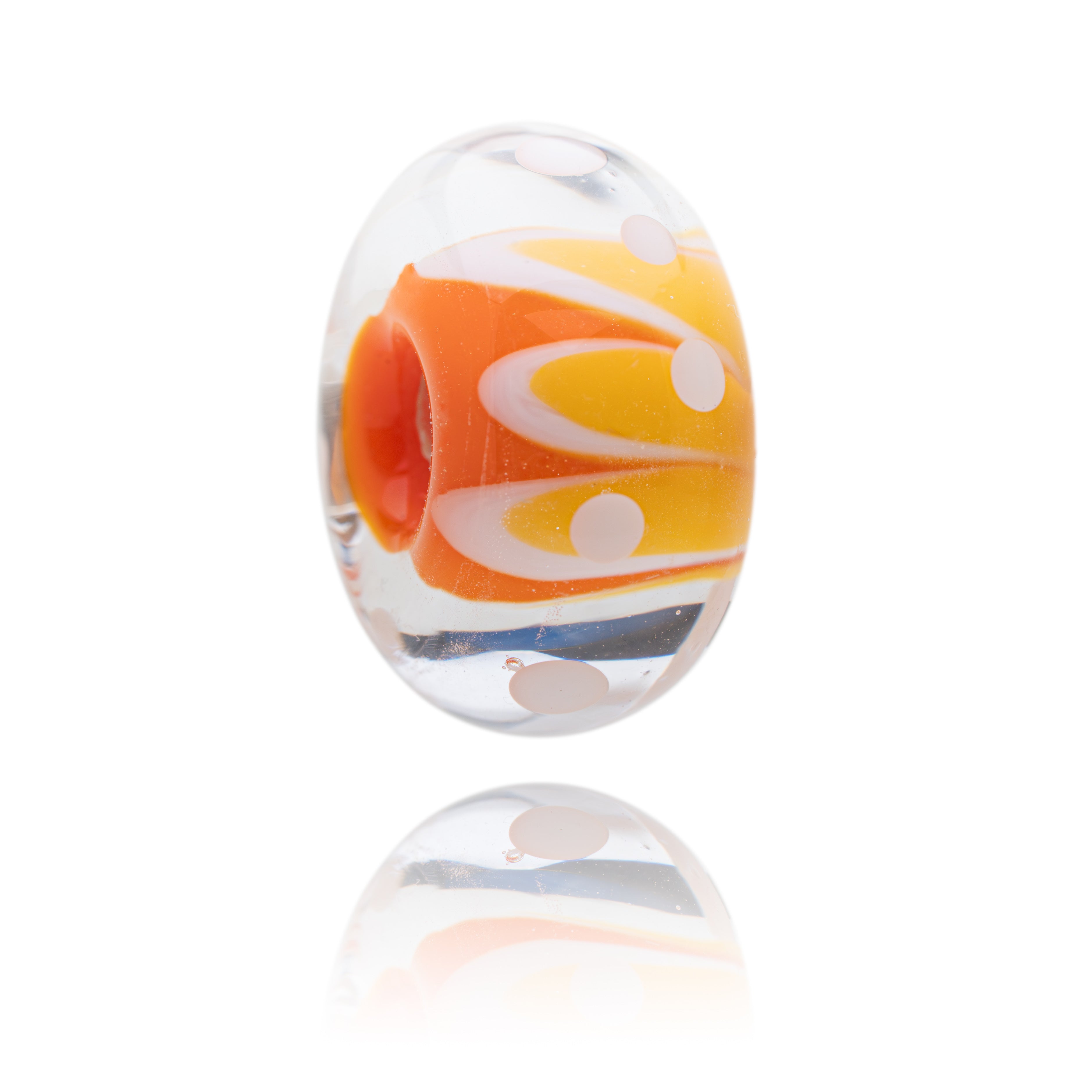 Colorful glass bead with orange, yellow, and white swirls on a white background