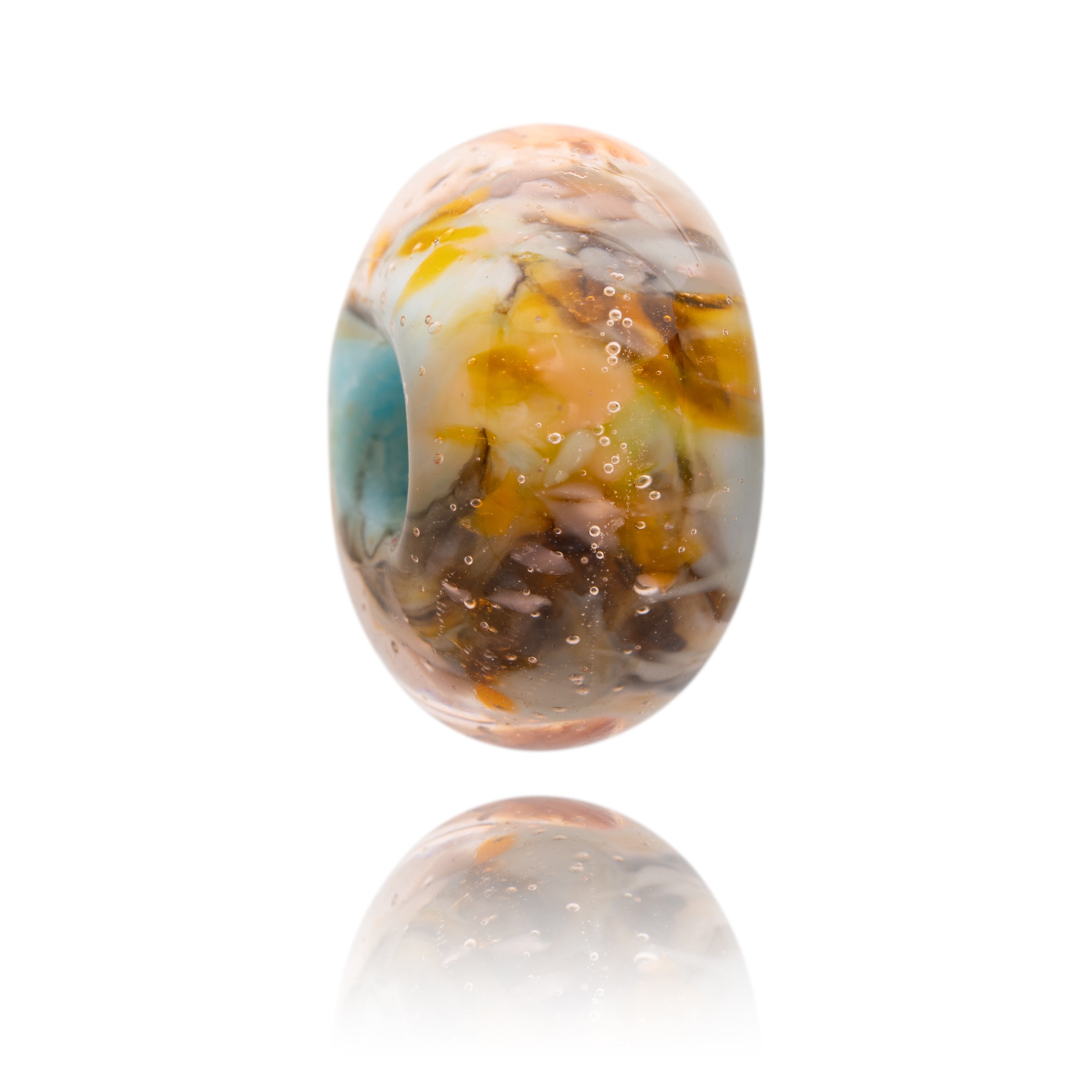 Brown, yellow and blue glass bead representing Little Fistral Beach in Cornwall.