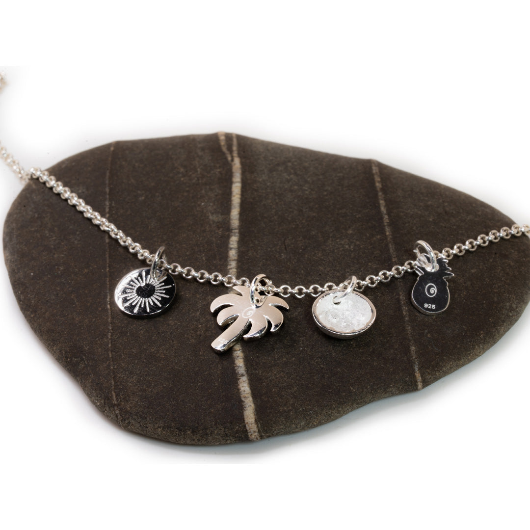 Necklace with charms on a brown stone surface