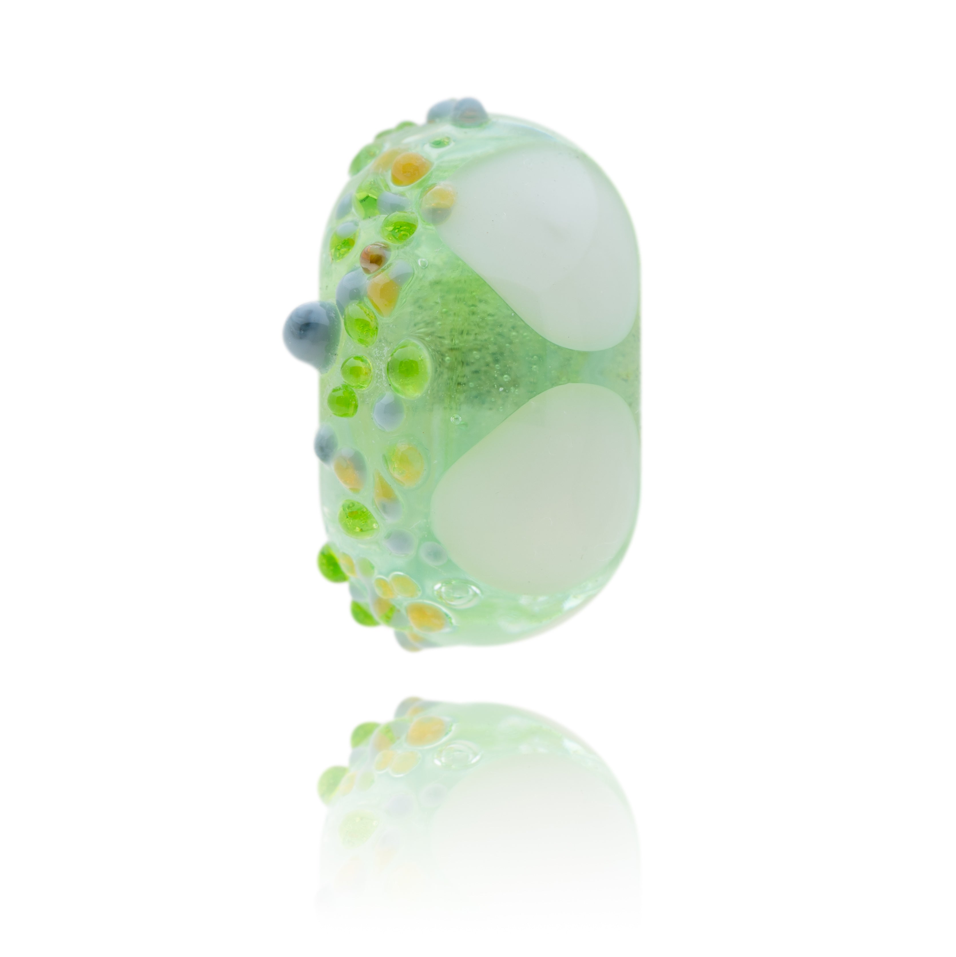 Green glass bead with white triangles and raised grey and amber spots on the other, representing Minehead in Somerset.
