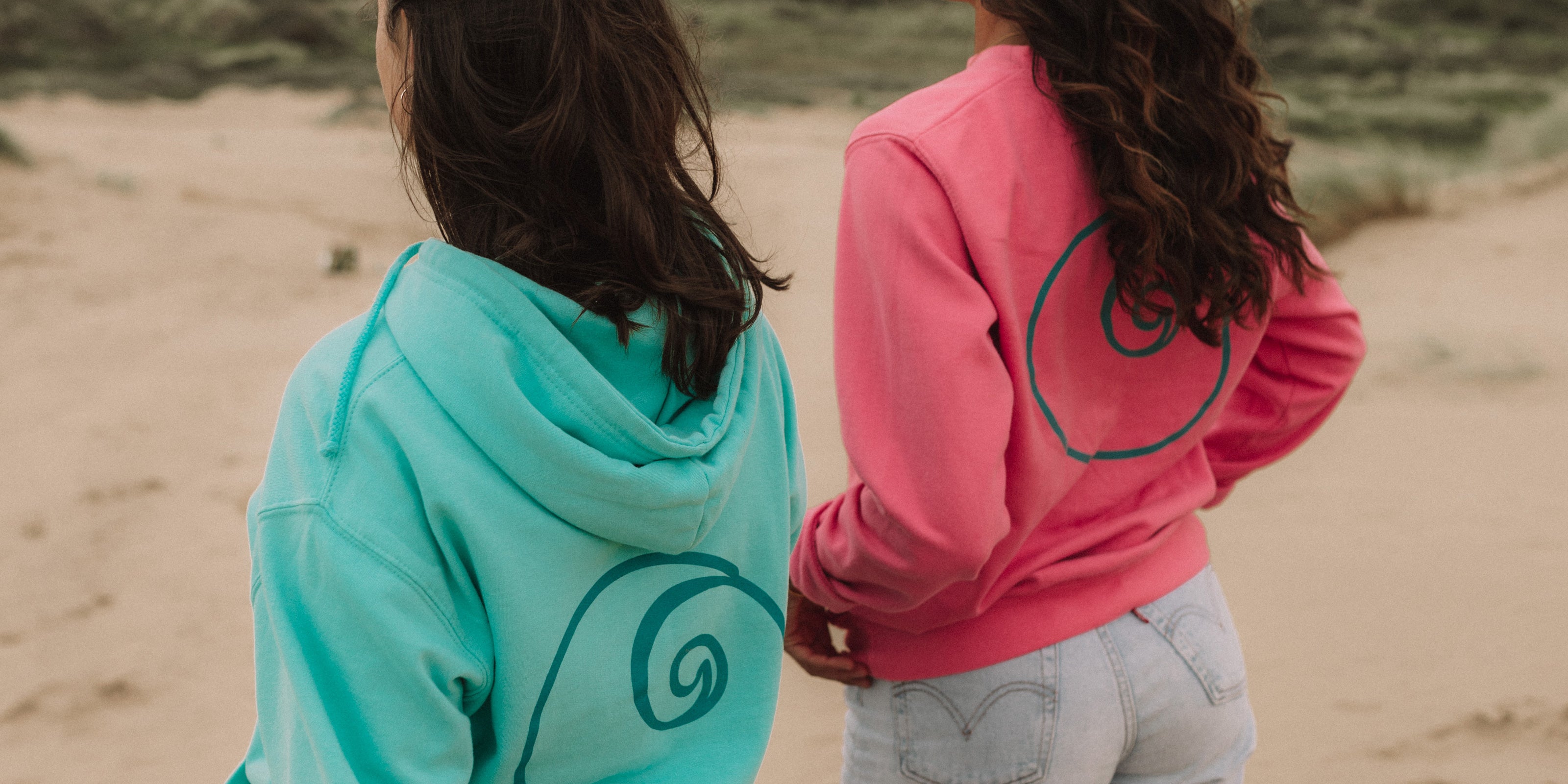 Turquoise and Pink Nalu Sweatshirt and Hoodies worn on the beach.