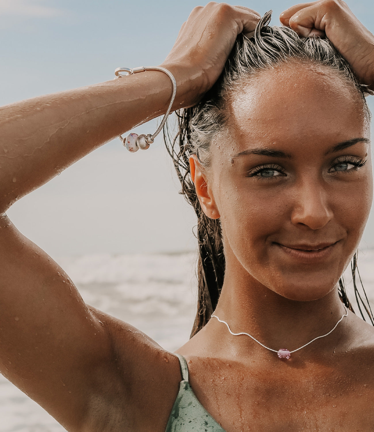 Girl wearing silver bracelet with Plastic Free charity bead.