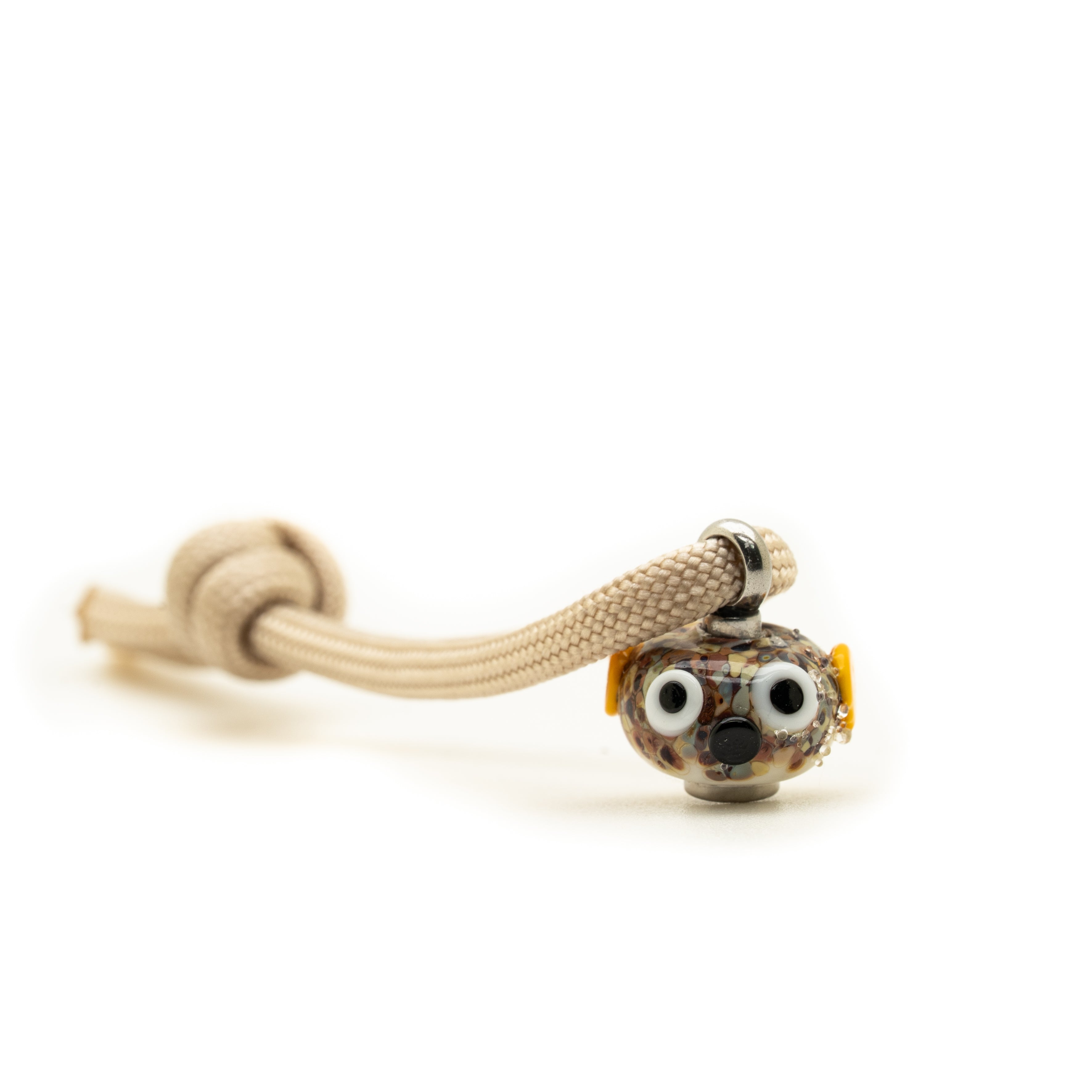 Puffer fish glass charm on sand cord.