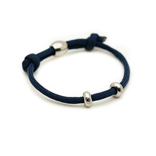 Navy blue bracelet with silver metal clasps on a white background
