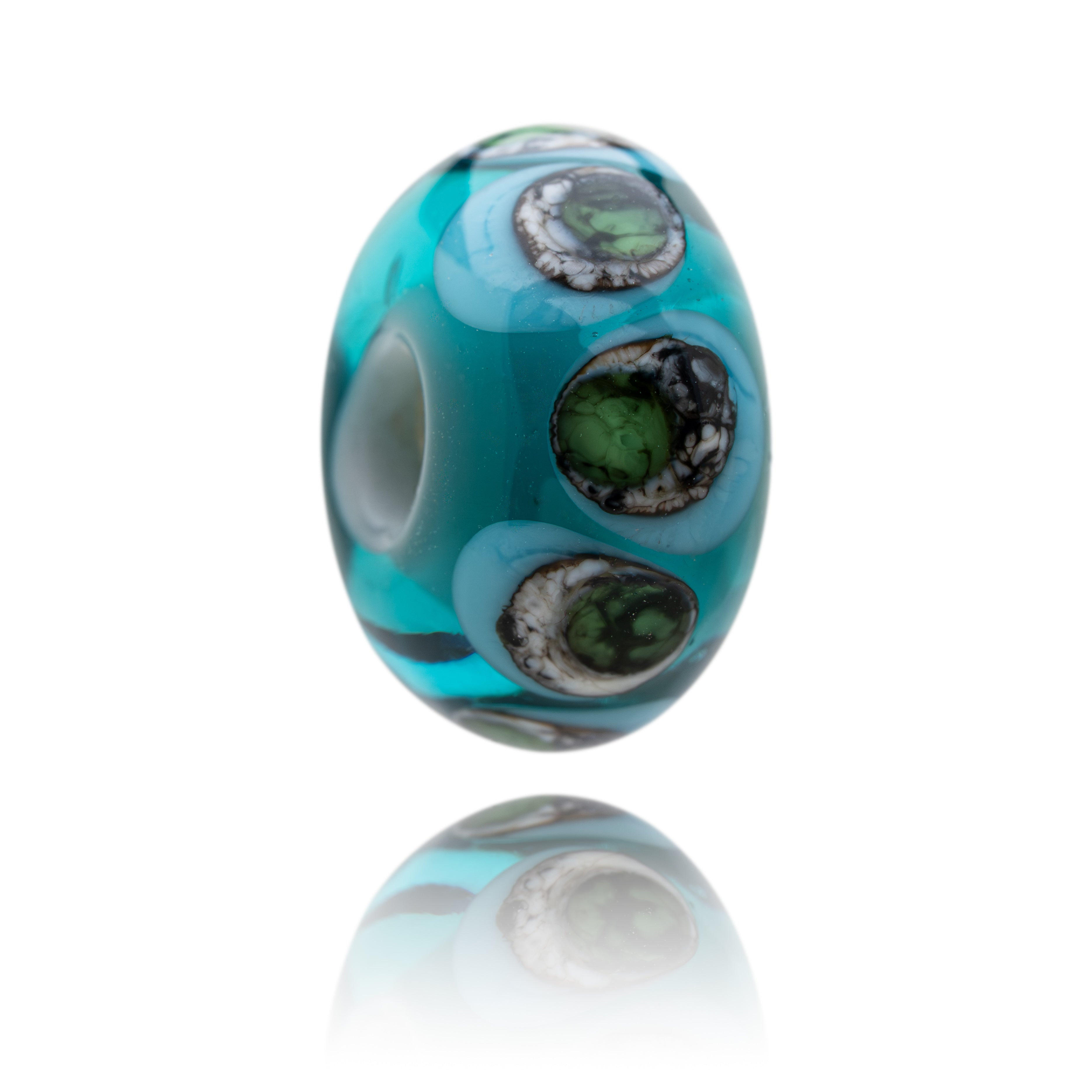 Turquoise glass bead with green and black swirls on a white background