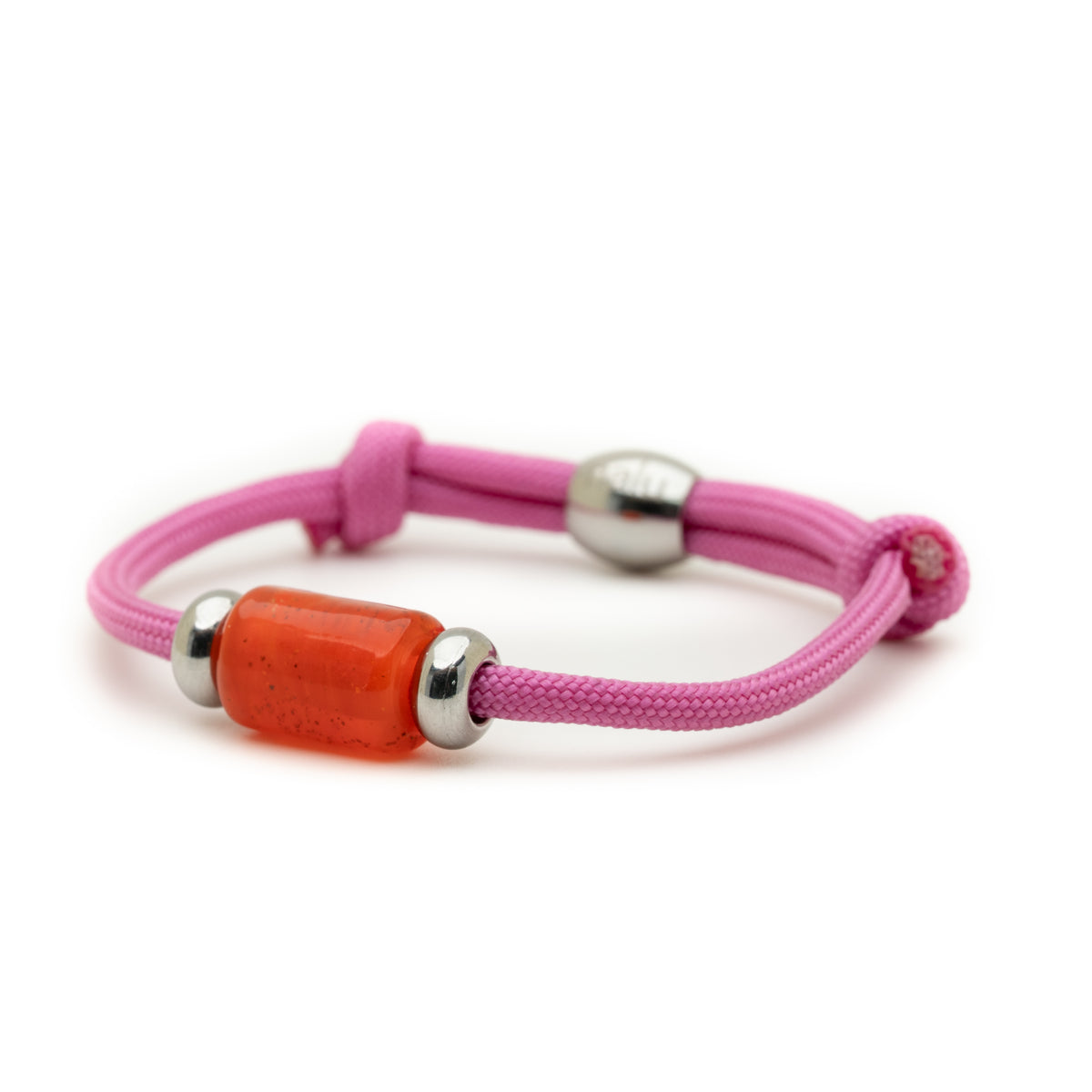A pink cord bracelet featuring a central translucent orange-red cylindrical bead flanked by two silver metal spacers, shown on a plain white background.