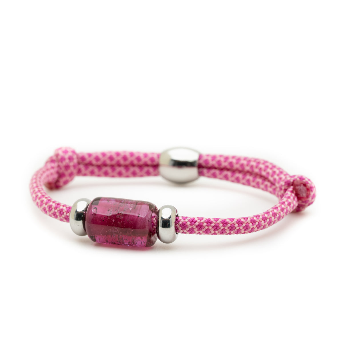 A pink braided cord bracelet with a central faceted magenta glass bead and polished silver metal beads, shown on a white background.