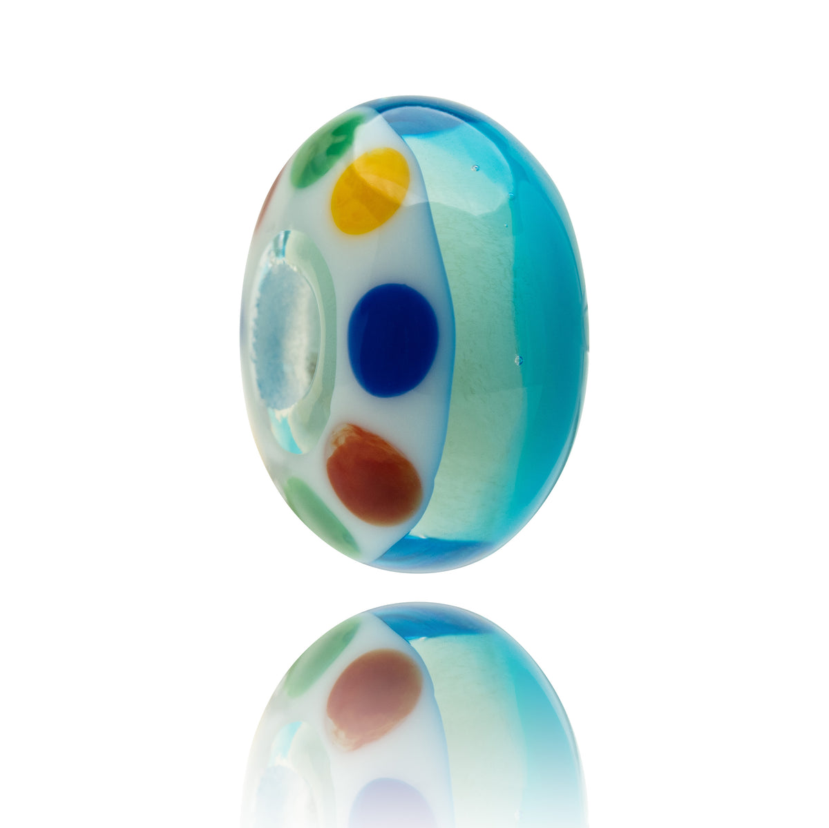 A single oval glass lampwork bead with a blue, white, and multicolor spotted pattern, shown on a reflective white surface.