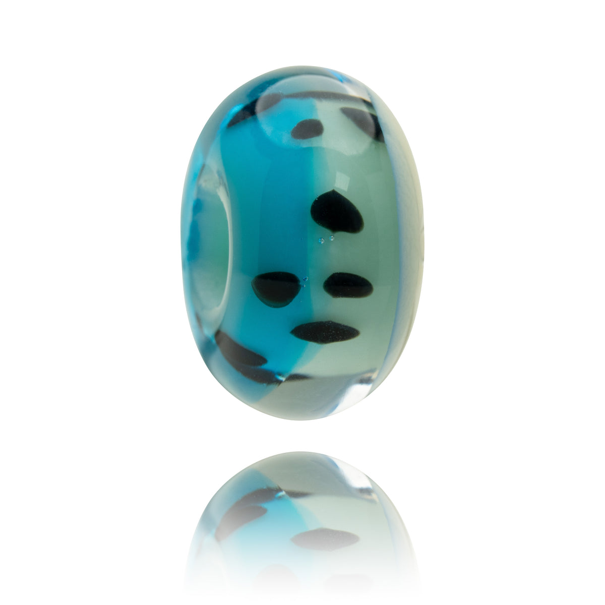 A single oval glass bead charm with a blue and light green marbled pattern and black spots, shown on a white background with a soft reflection below.