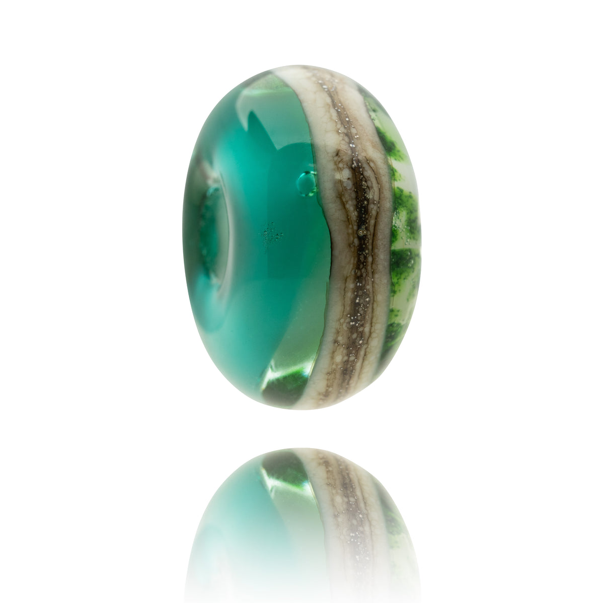 A single oval glass lampwork bead with a vibrant teal green center and a textured, layered outer band of beige, brown, and green, shown floating above a clean white reflective surface.