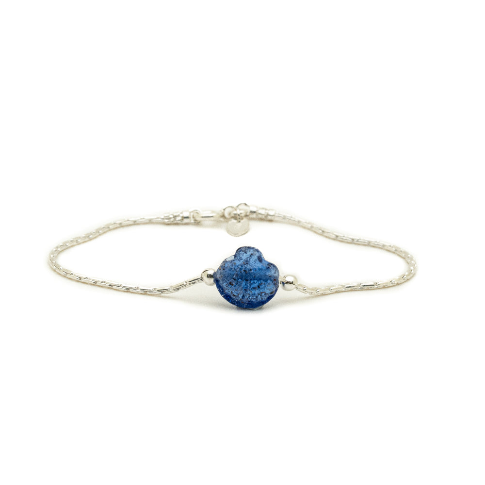 Silver bracelet with a blue glass shell on a white background