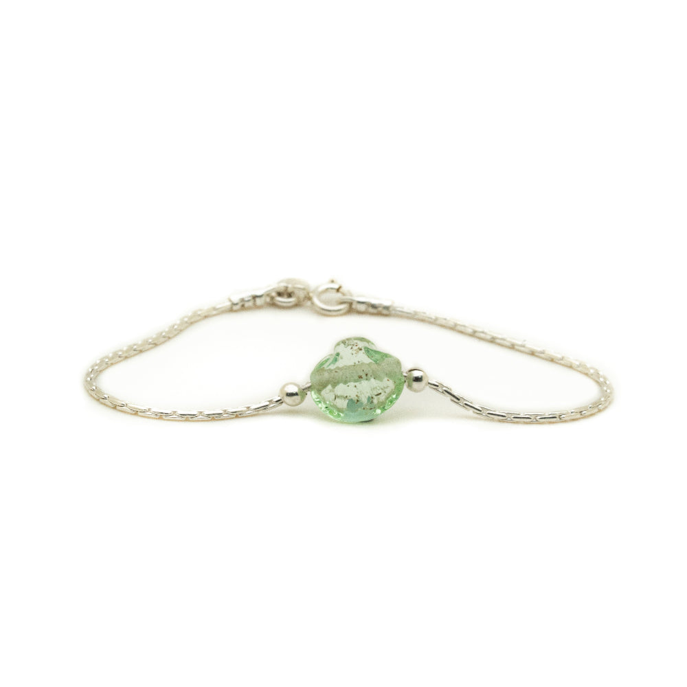 Silver bracelet with a green shell-shaped charm on a white background