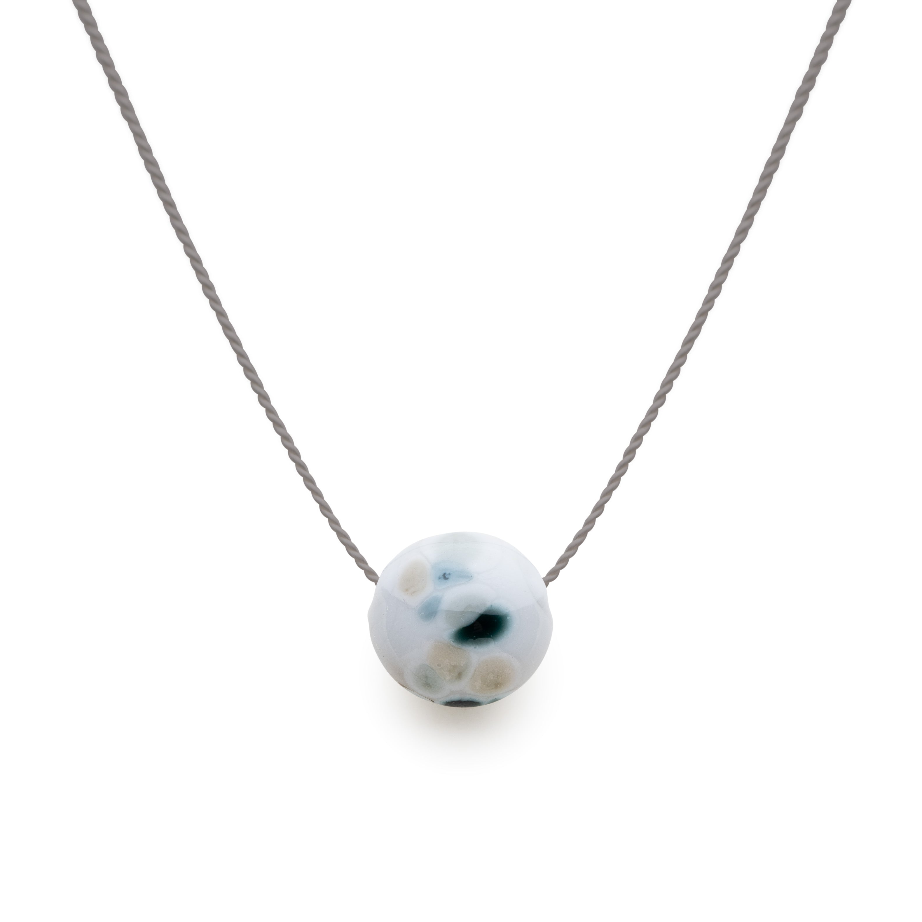 Seal sanctuary pebble necklace on grey silk.