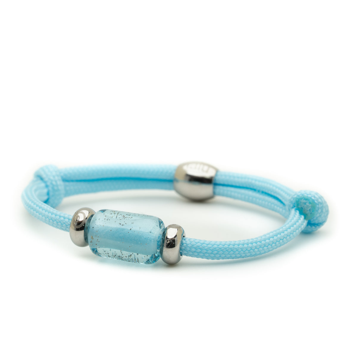 A light blue cord bracelet with a textured cylindrical glass bead and polished silver metal spacer beads, shown on a clean white background.