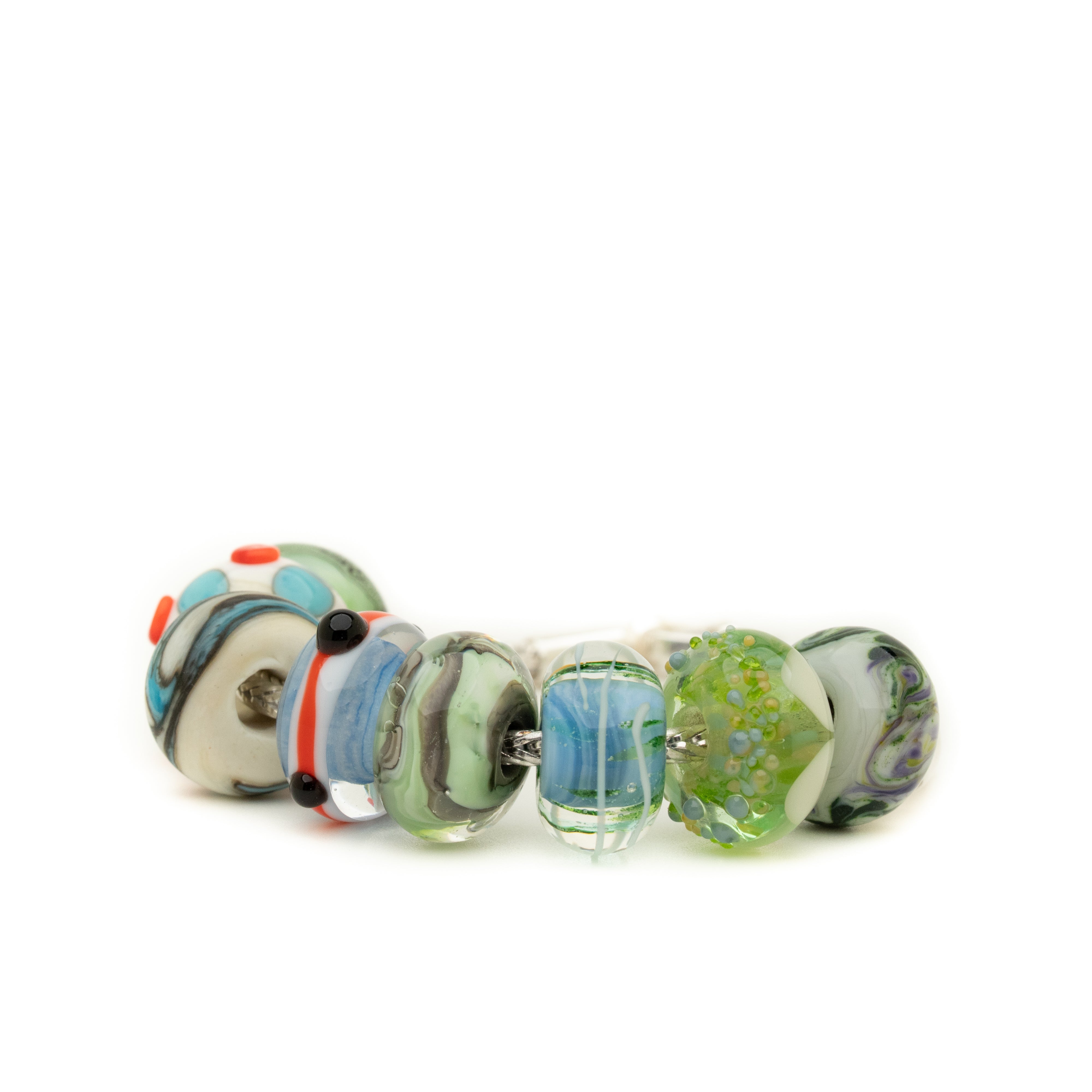 Silver bracelet with eight glass lamp work beads in shades of blues, greys and green with some red.