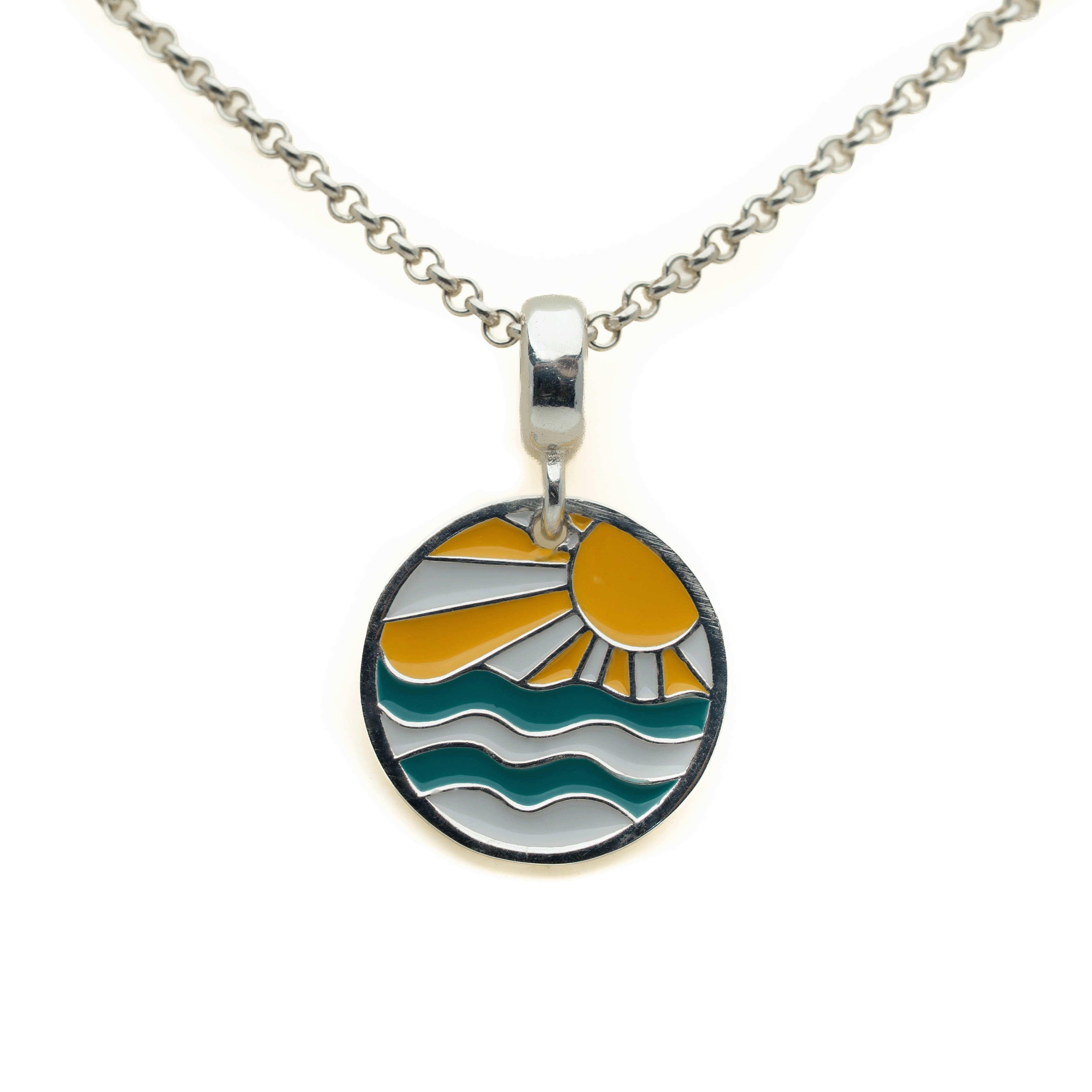 A silver chain necklace with a round pendant featuring an enamel sunset and ocean wave design in yellow, teal, and silver.