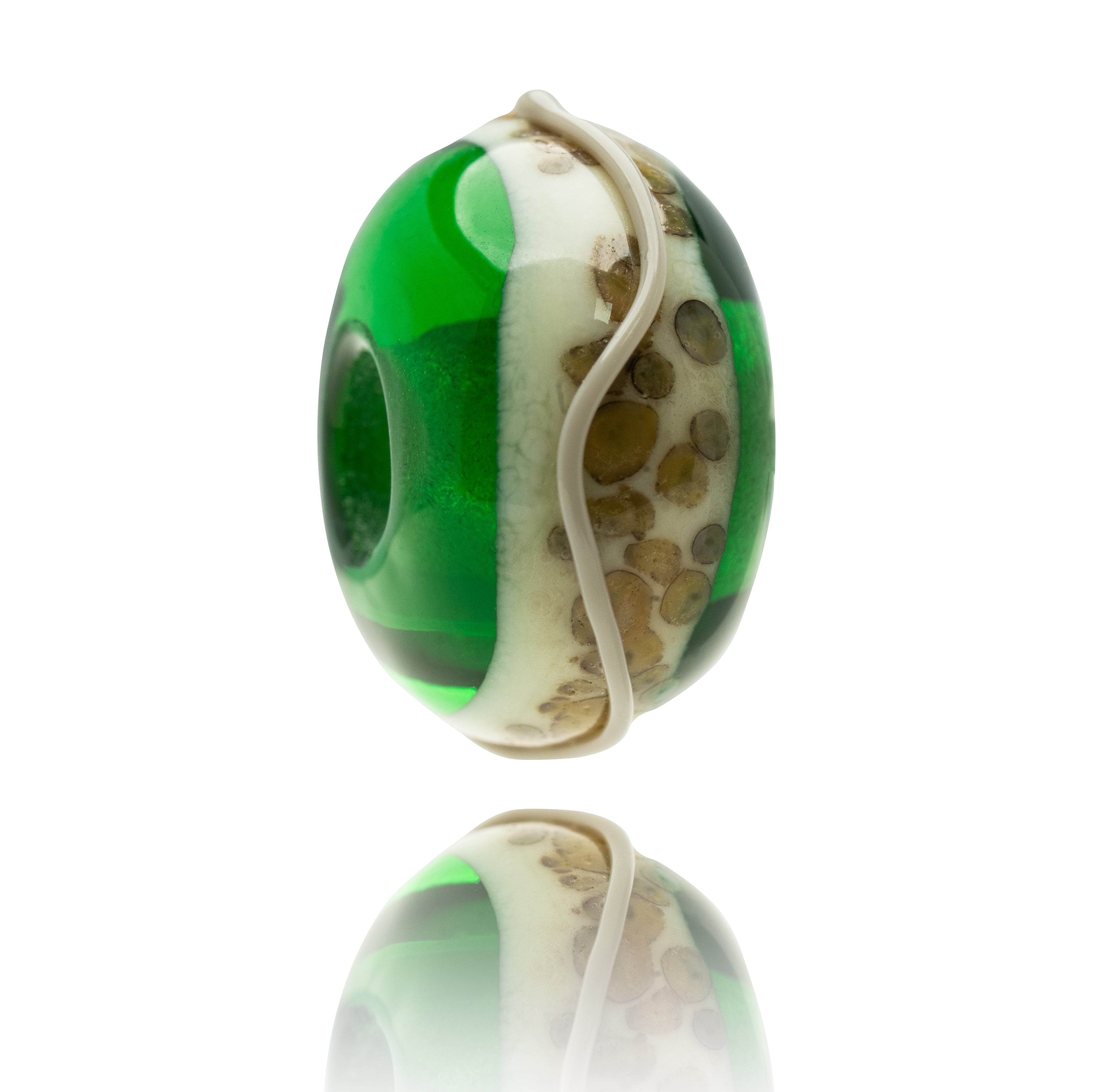 Green glass bead with cream and brown spotted pattern on the surface.