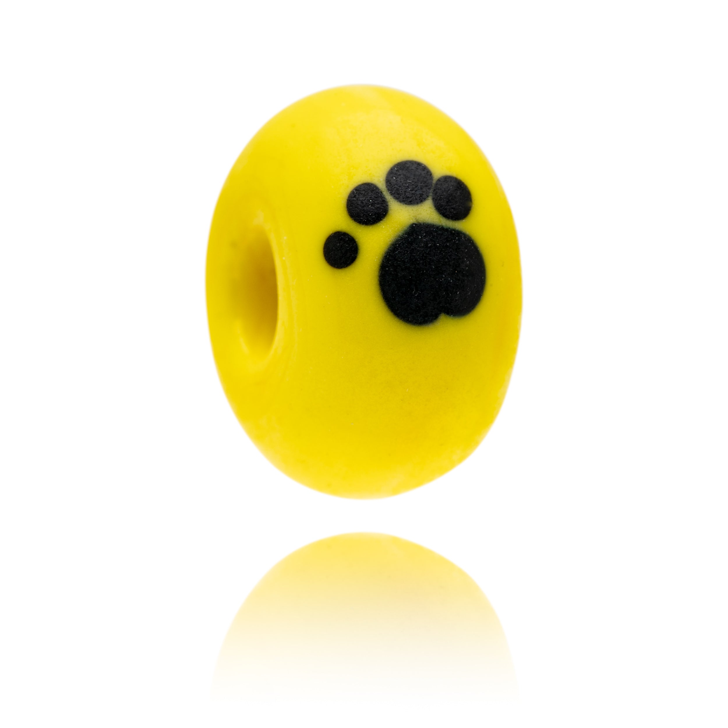 Yellow glass bead decorated with black dog paw print for the Dogs Trust.