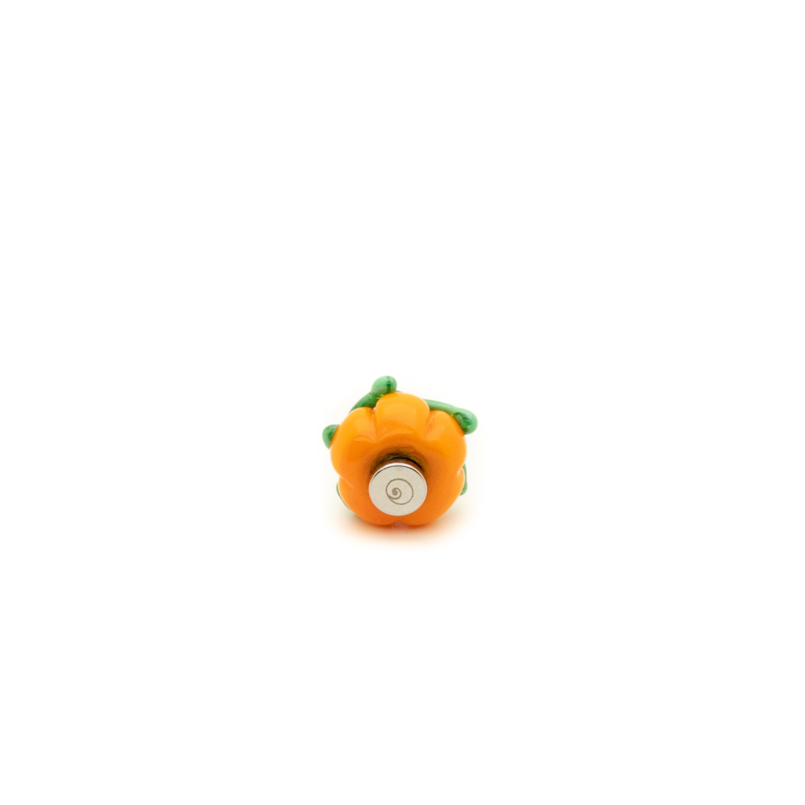 Small orange object with a green top on a white background