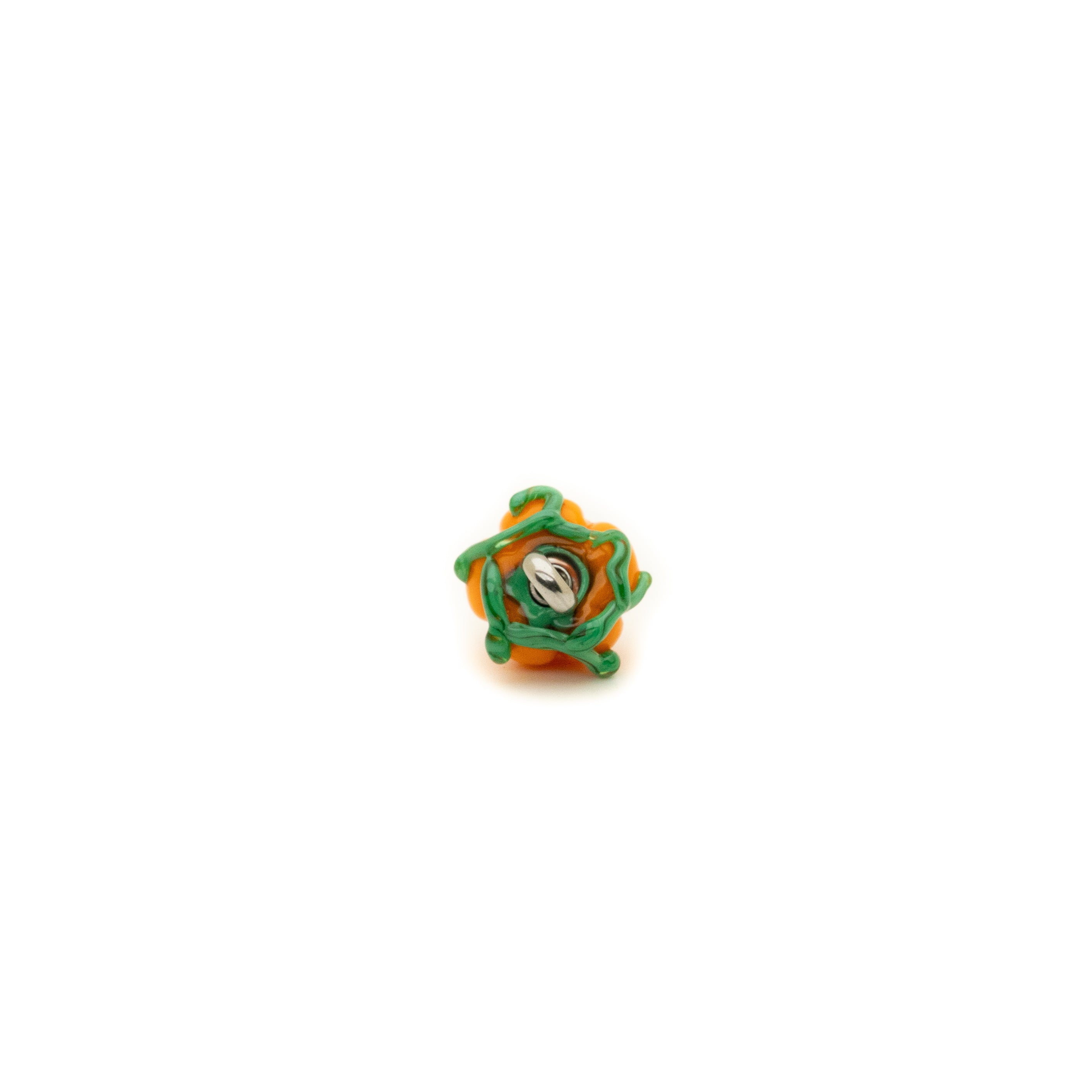 Small decorative item with green and orange design on a white background