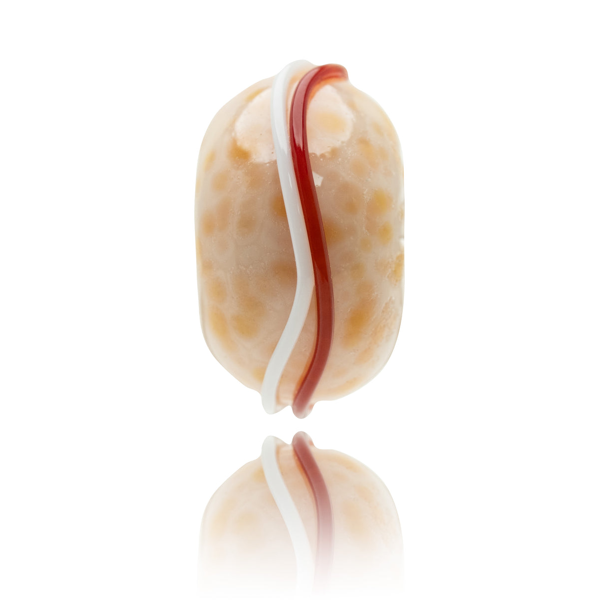 A single oval bead with a glossy cream and light brown marbled pattern, featuring a vertical wavy stripe of white and red, shown on a reflective white surface.