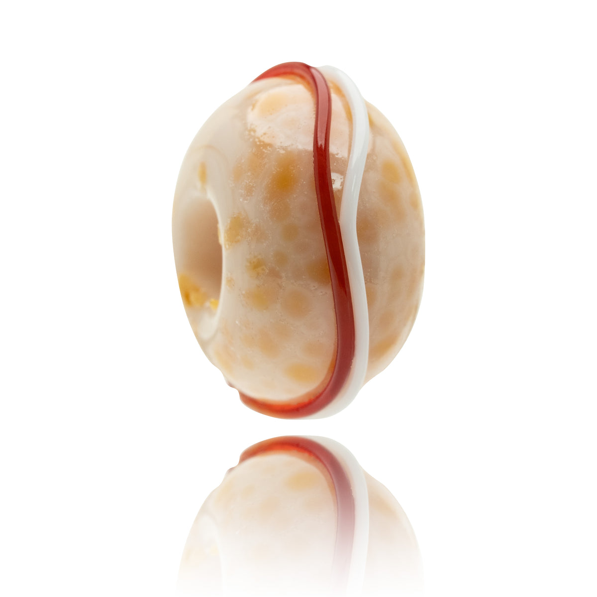 A single round translucent bead or charm with a warm cream and pale yellow marbled pattern, featuring a prominent vertical red stripe and a white stripe, shown on a reflective white background.