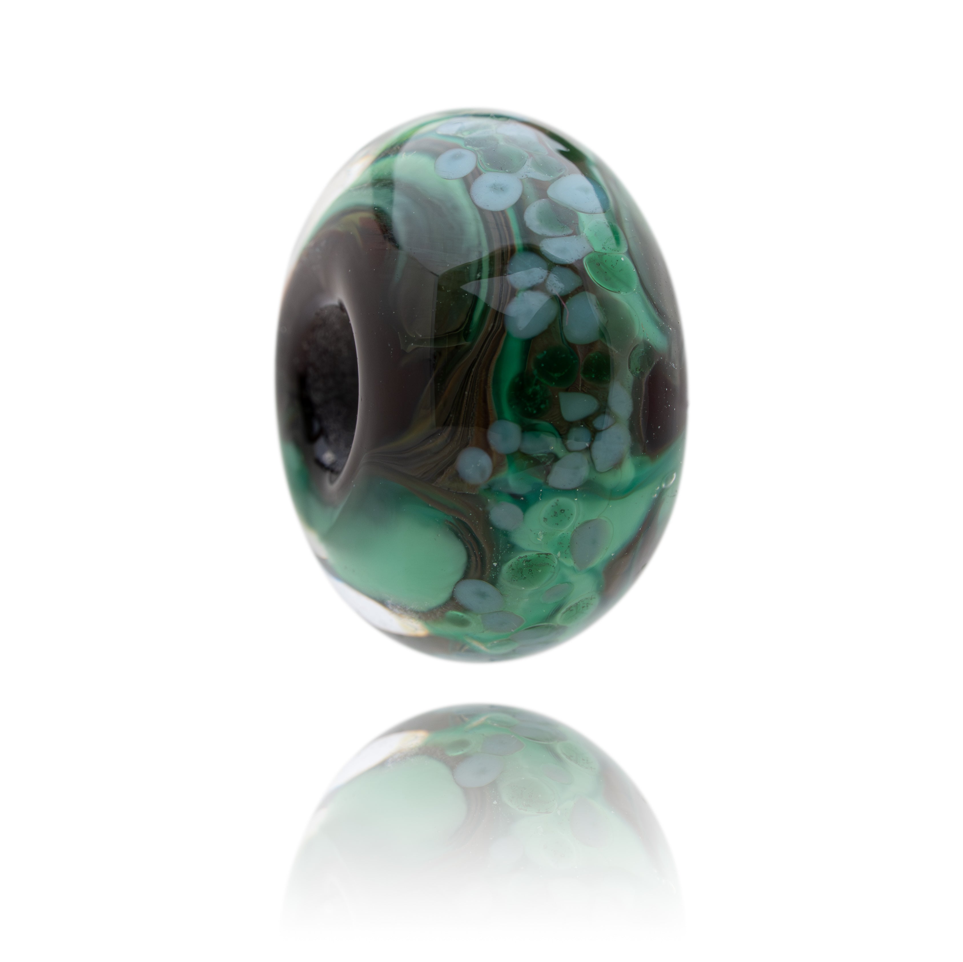 Green and brown marbled glass bead on a white background