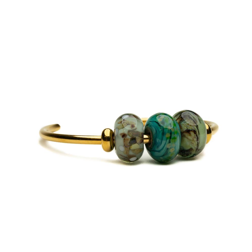 Grey, green, brown glass beads representing Welsh national parks on gold bangle.