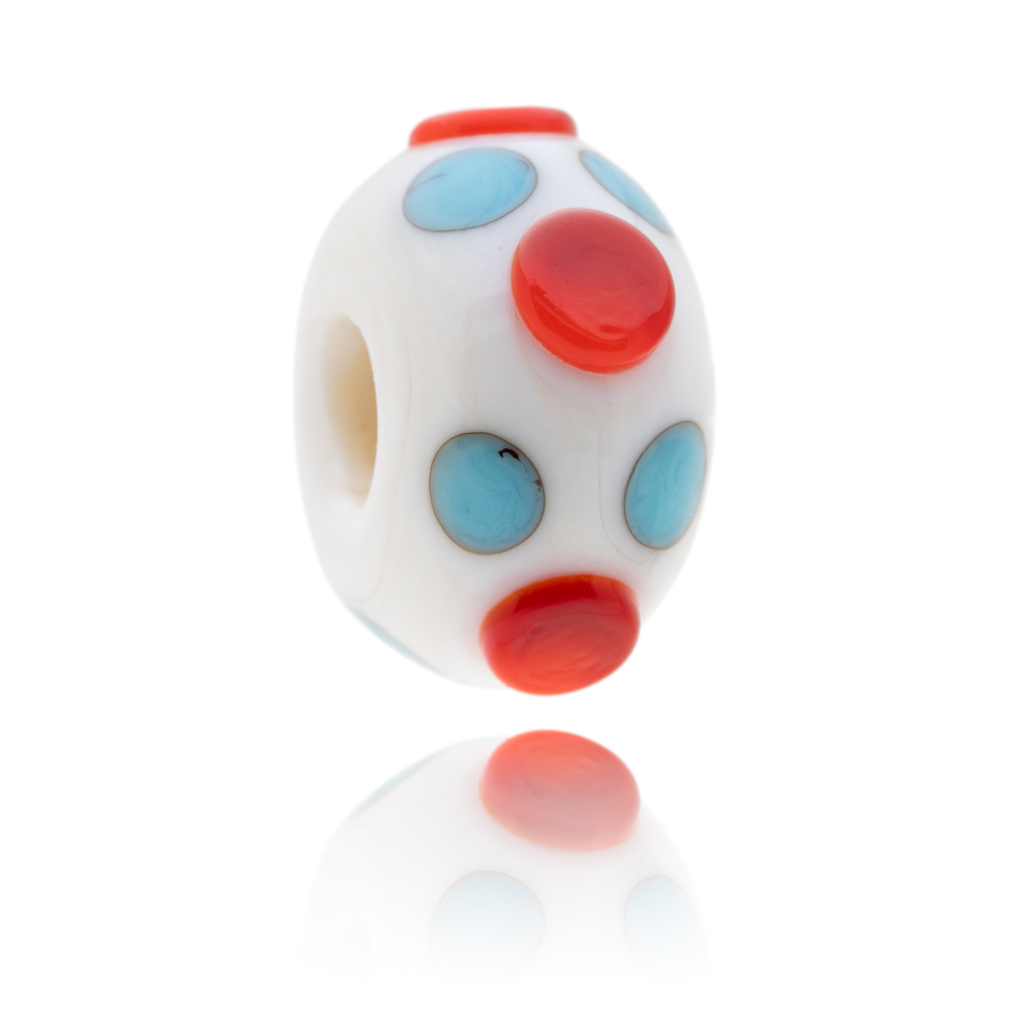 Light ivory coloured glass bead decorated with little turquoise and larger red dots to represent Weston-super-Mare in Somerset.