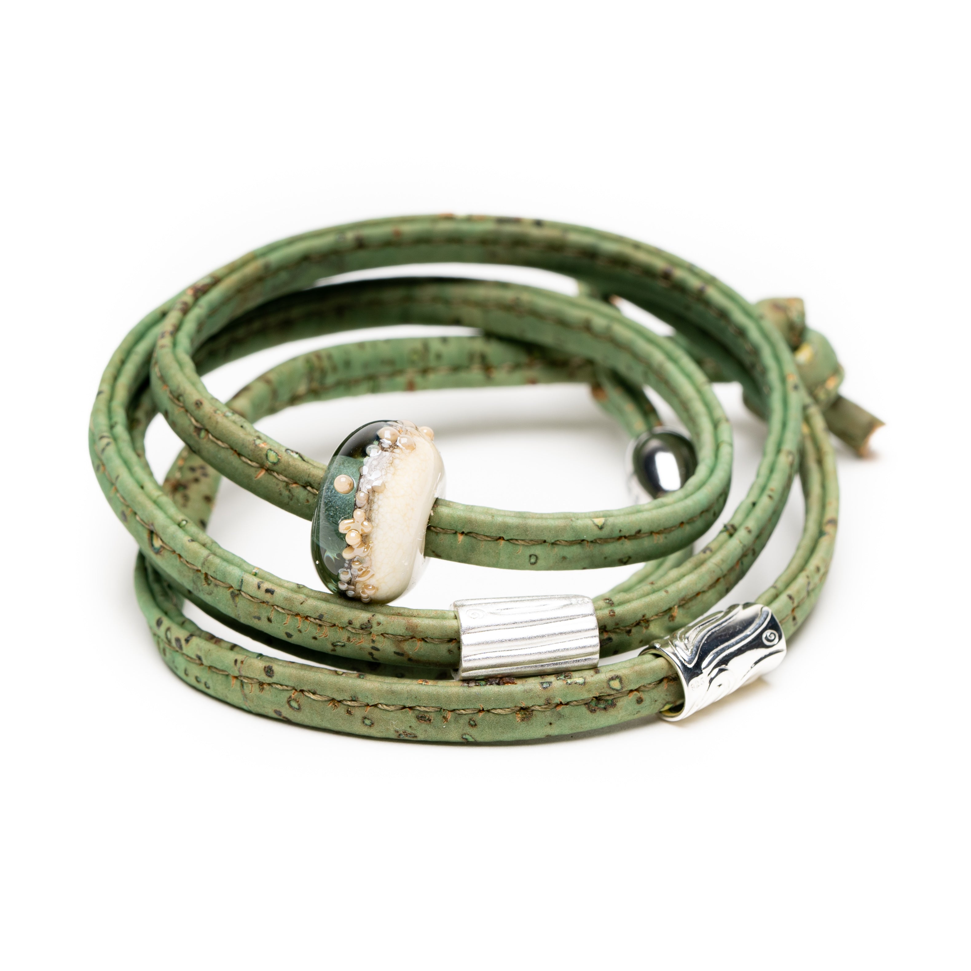 Green cork wrap bracelet with a silver clasp on a white background
