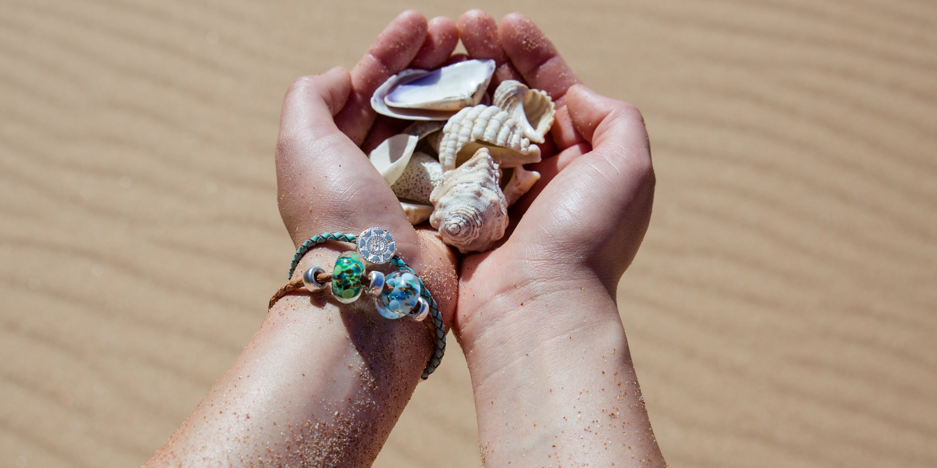 Jersey and Guernsey surf collection beads on bracelet, collecting shells on the beach.