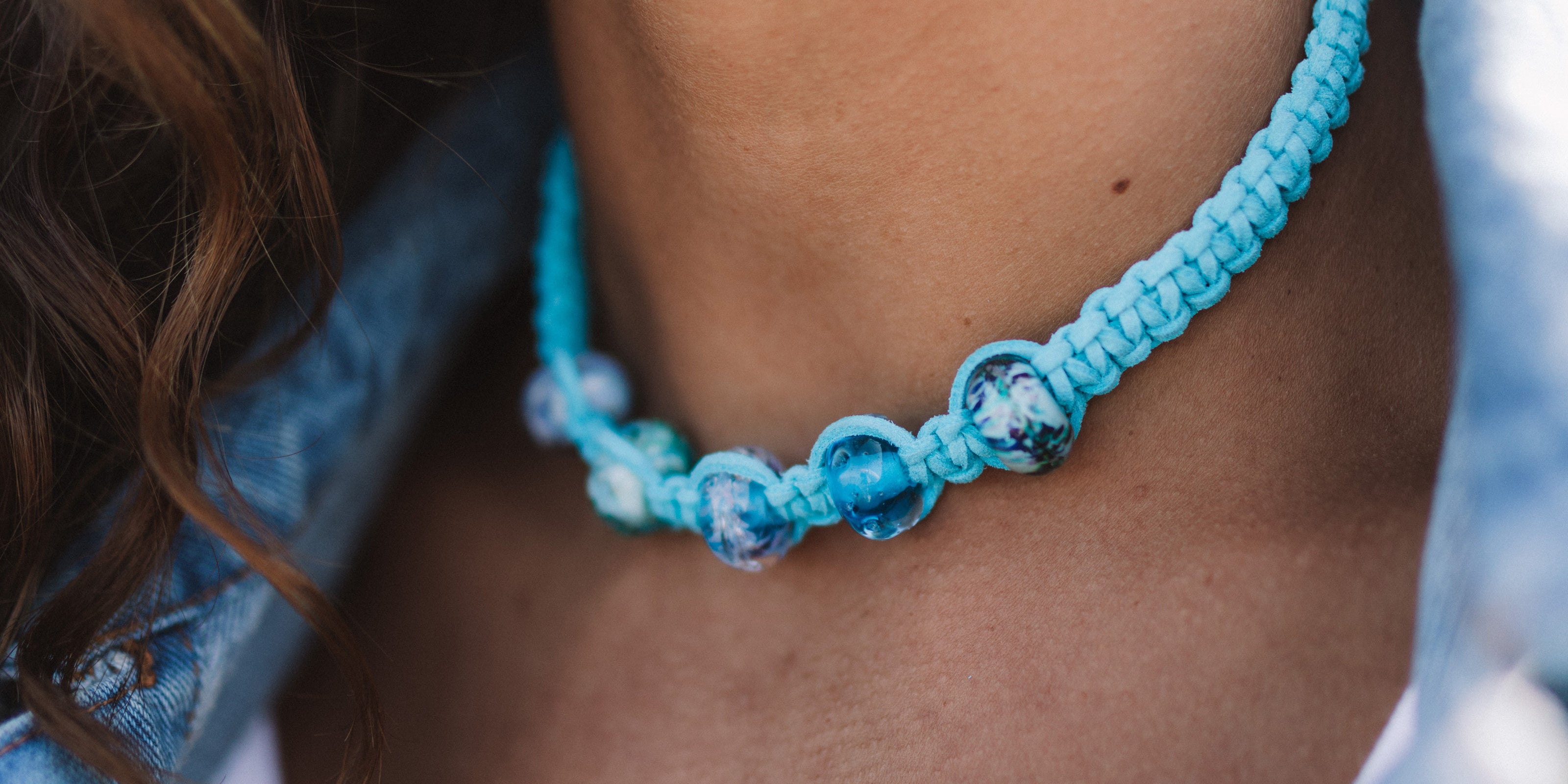 Cornish beads in shades of blue on turquoise macrame chocker necklace.