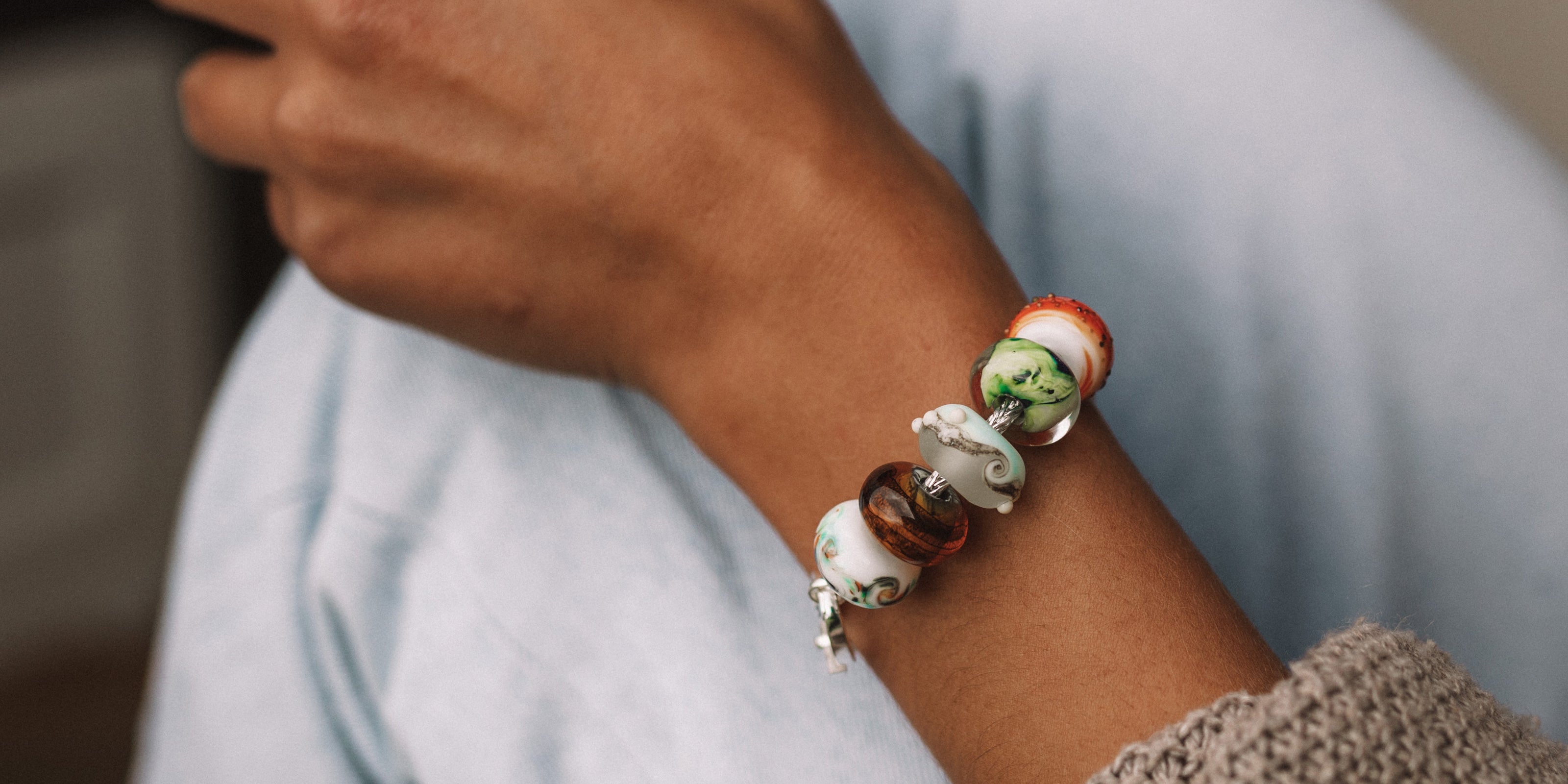 Dorset beach inspired glass beads in autumn colours worn on silver bracelet.