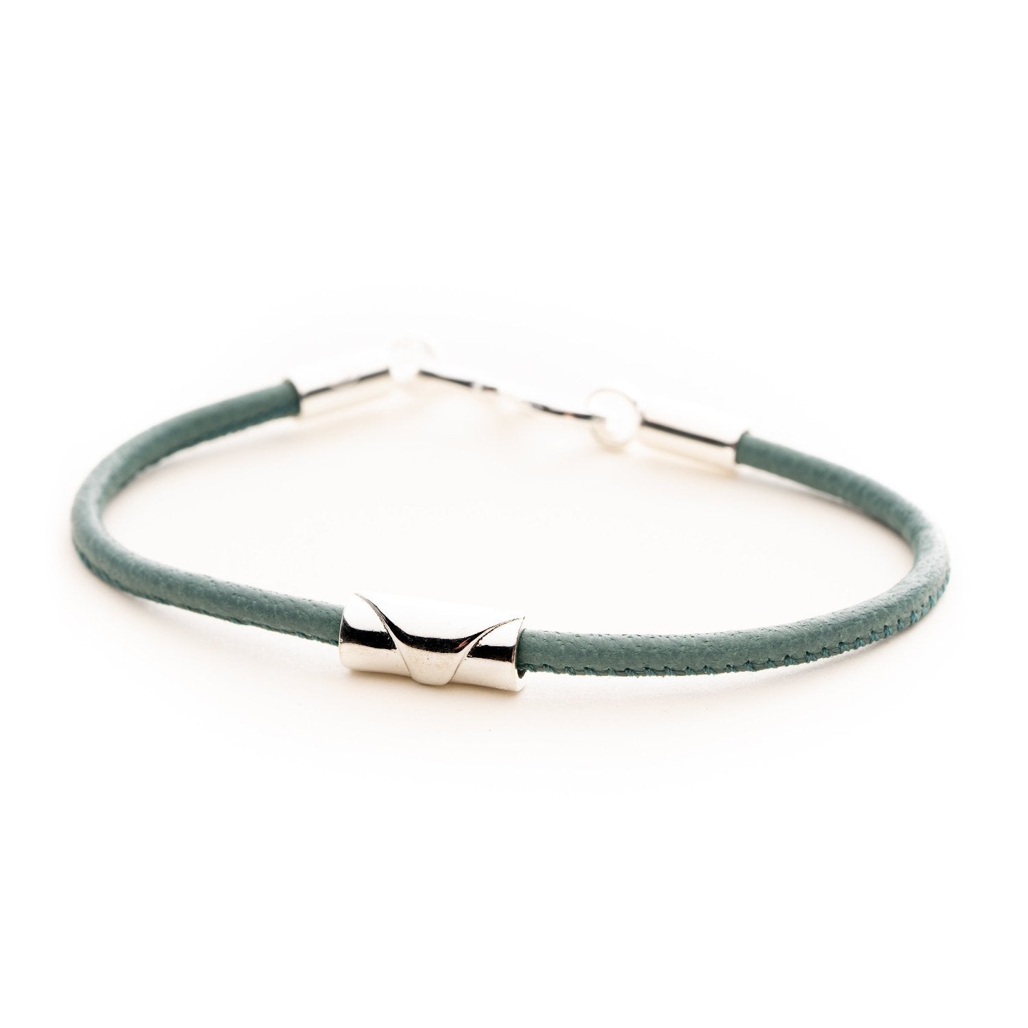 Silver perfect wave bead on a leather bracelet.