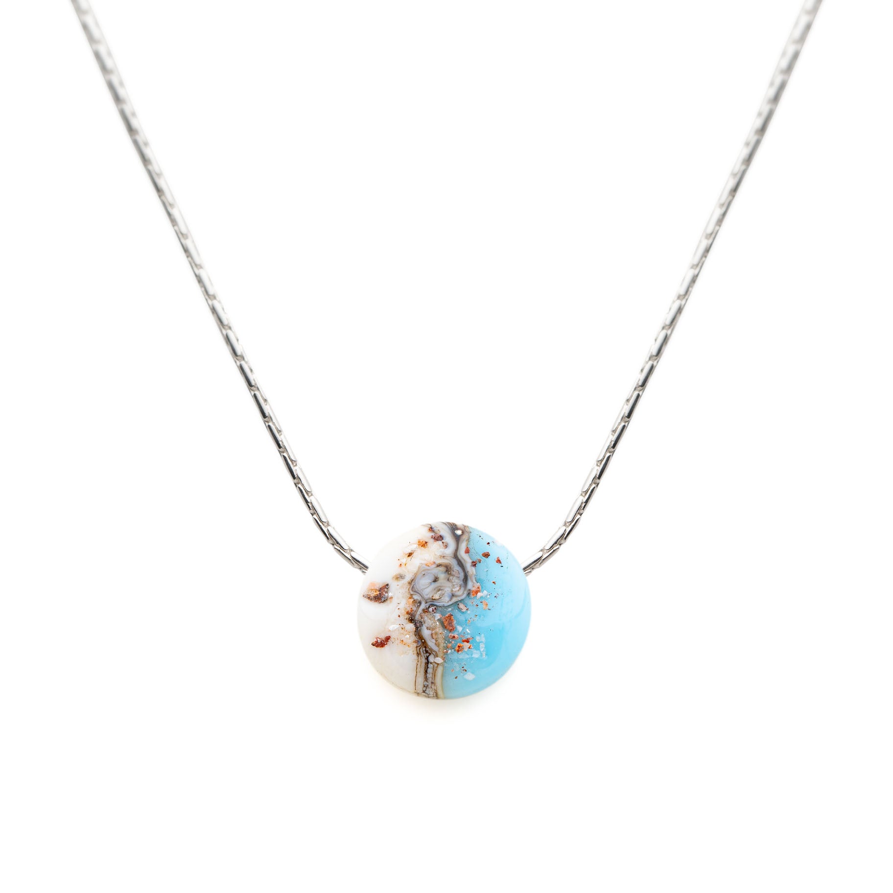 Necklace with a round, multicolored pendant on a white background